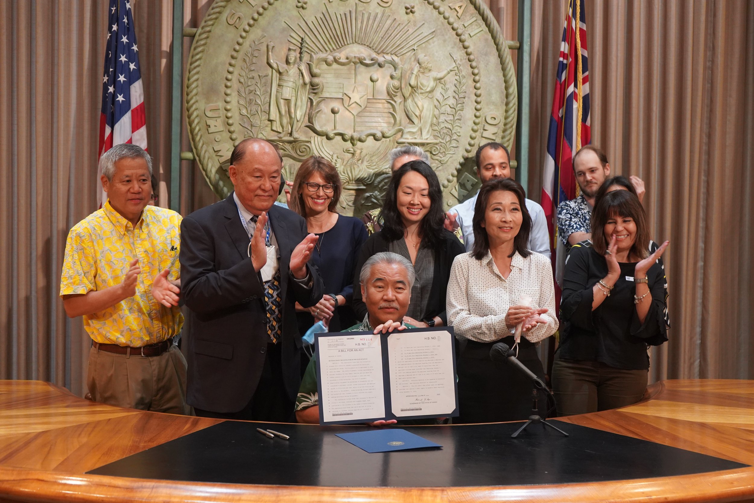 Ige signs $18 minimum wage increase, tax refund