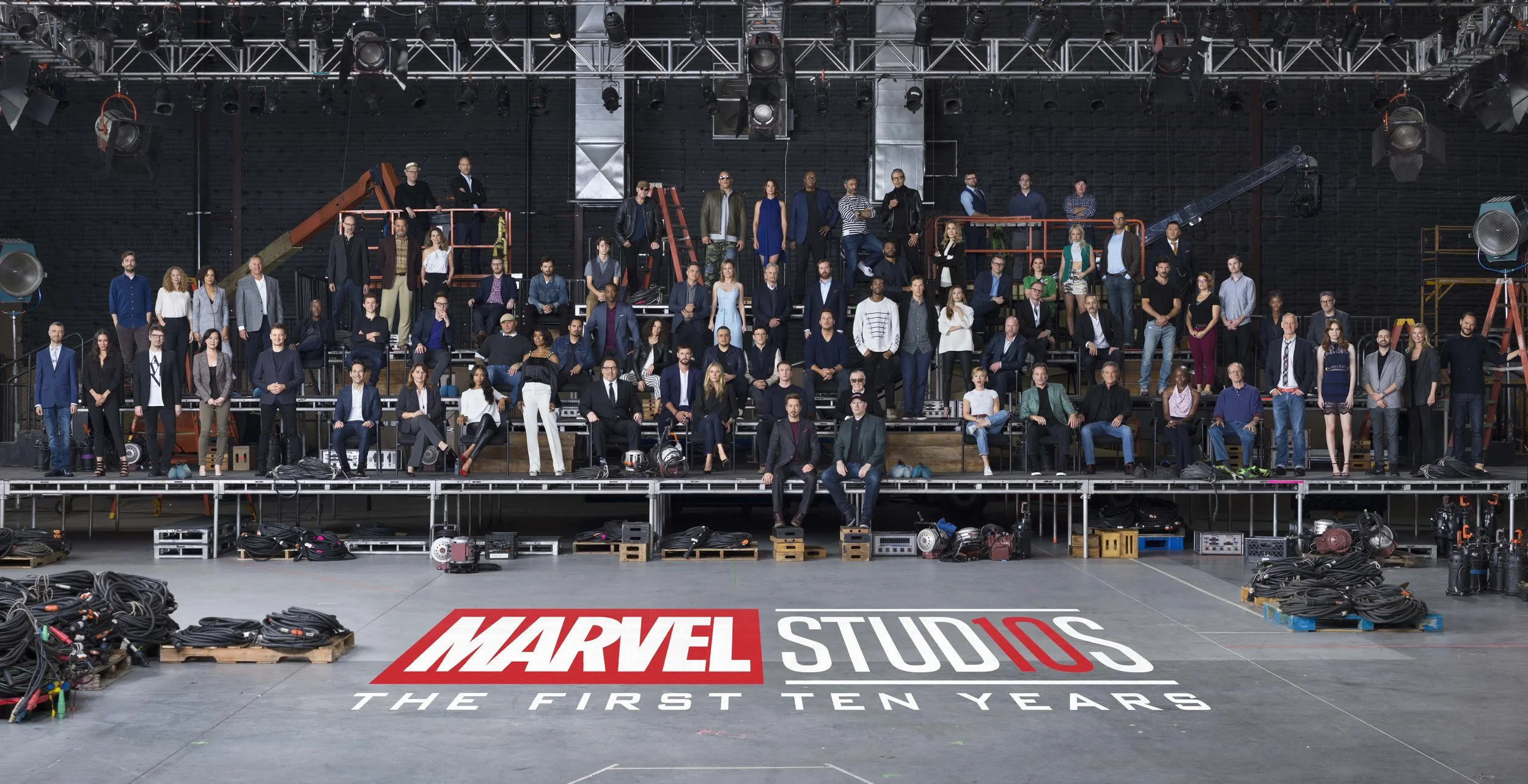 Marvel Studios “The First Ten Years” Class Photo
Front Row L to R: Sean Gunn (Kraglin), Hannah John-Kamen (Ghost), Director Scott Derrickson, Executive Producer Trinh Tran, Jeremy Renner (Hawkeye), Paul Rudd (Ant-Man), EVP, Physical Production Victoria Alonso, Zoe Saldana (Gamora), Angela Bassett (Ramonda), Director/Actor Jon Favreau (Happy Hogan), Chris Hemsworth (Thor), Gwyneth Paltrow (Pepper Potts), Chris Evans (Captain America), Robert Downey Jr. (Iron Man), Executive Producer/Writer Stan Lee, President of Marvel Studios Kevin Feige, Scarlett Johansson (Black Widow), Co-President of Marvel Studios Louis D’Esposito, Kurt Russell (Ego), Danai Gurira (Okoye), William Hurt (Thaddeus Ross), Director Alan Taylor, Karen Gillan (Nebula), Executive Producer Brad Winderbaum, Emily VanCamp (Sharon Carter), Director Louis Letterier
Second Row L to R: Director Jon Watts, Casting Director Sarah Finn, Tessa Thompson (Valkyrie), VP, Physical Production David Grant, Don Cheadle (War Machine), Tom Holland (Spider-Man), Director James Gunn, Dave Bautista (Drax), Michael Peña (Luis), Anthony Mackie (Falcon), Evangeline Lilly (Wasp), Director Joe Russo, Director Anthony Russo, Chris Pratt (Star-Lord), Chadwick Boseman (Black Panther), Benedict Cumberbatch (Doctor Strange), Elizabeth Olsen (Scarlet Witch), Director Joss Whedon, Paul Bettany (Vision), VP, Physical Production Mitchell Bell, Frank Grillo (Crossbones), Director Anna Boden, Director Ryan Fleck, Letitia Wright (Shuri), Editor Jeffrey Ford
Third Row L to R: Director Peyton Reed, Laurence Fishburne (Dr. Bill Foster), Linda Cardellini (Laura Barton), Executive Producer Jonathan Schwartz, Sebastian Stan (Winter Soldier), Ty Simpkins (Harley Keener), Mark Ruffalo (Hulk), Brie Larson (Captain Marvel), Michael Douglas (Hank Pym), Executive Producer Stephen Broussard, Director Ryan Coogler, Michelle Pfeiffer (Janet van Dyne), Executive Producer Jeremy Latcham, Hayley Atwell (Peggy Carter), Pom Klementieff (Mantis), Executive Producer Nate Moore, Benedict Wong (Wong)
Fourth Row L to R: Screenwriter Christopher Markus, Screenwriter Stephen McFeely, Michael Rooker (Yondu), Vin Diesel (Groot), Cobie Smulders (Maria Hill), Samuel L. Jackson (Nick Fury), Director Taika Waititi, Jeff Goldblum (Grandmaster), Executive Producer Erik Carroll, Head of Visual Development Ryan Meinerding, Executive Producer/Screenwriter Craig Kyle
Photo Credit: Marco Grob
©Marvel Studios 2018