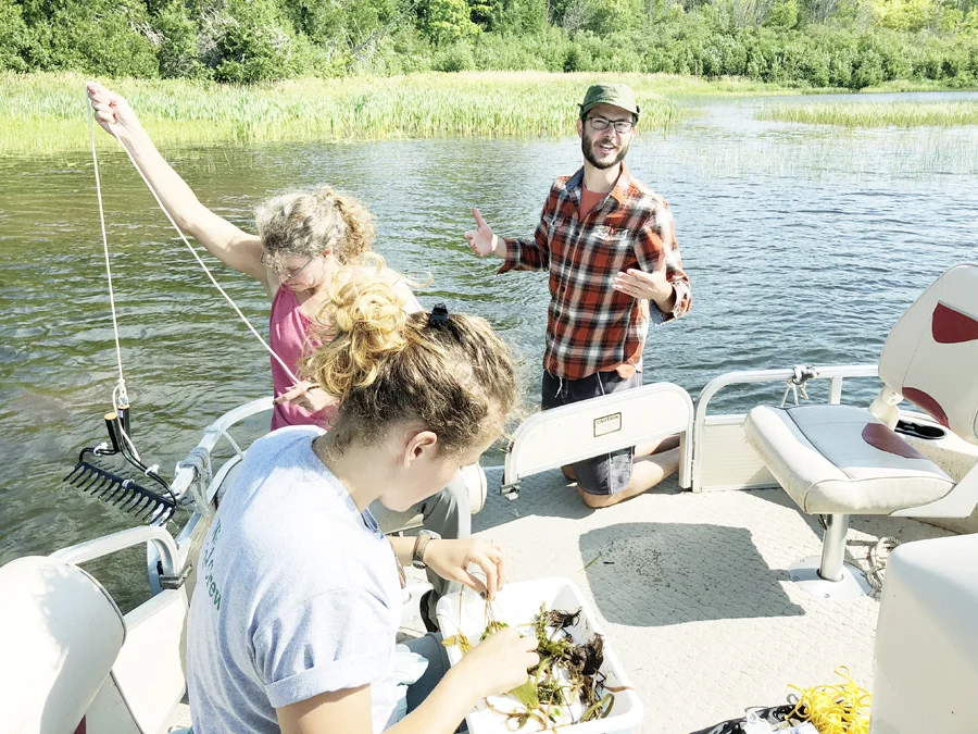 Pictured above are Erick Elgin (at right) and Keweenaw Invasive Species Management Area (KISMA) Coordinator Sigrid Resh and members of the KISMA weed crew sampling aquatic vegetation with a “weed rake” at Gratiot Lake during the EAPW training.