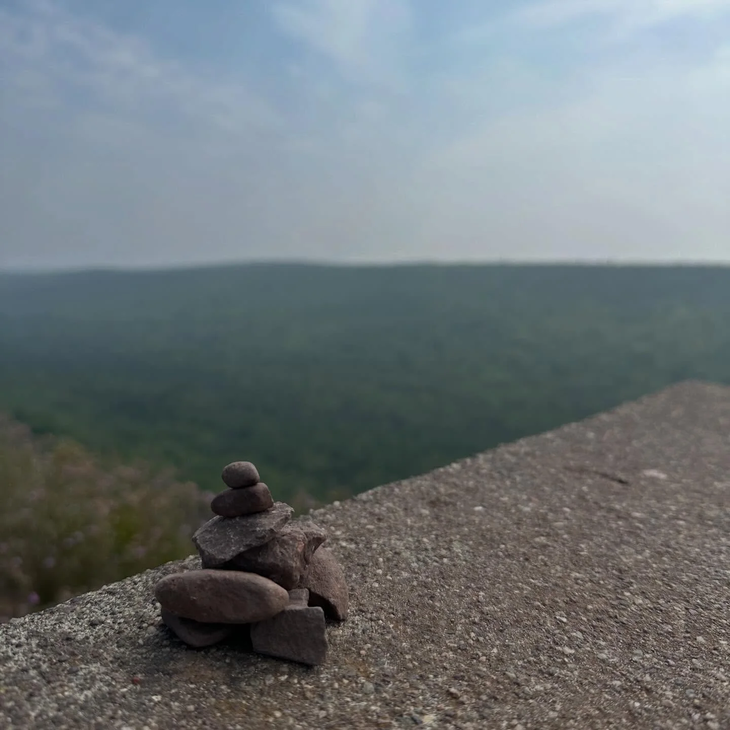 There is something peaceful about stones piled one atop another. Learn about cairns on today&rsquo;s yoopercabingrl blog: manninenscabins.com/cabin-blog/2026/3/13/cairns #cairns #yoopercabingrlblog #michiganblogger #otterlakelife #manninenscabins