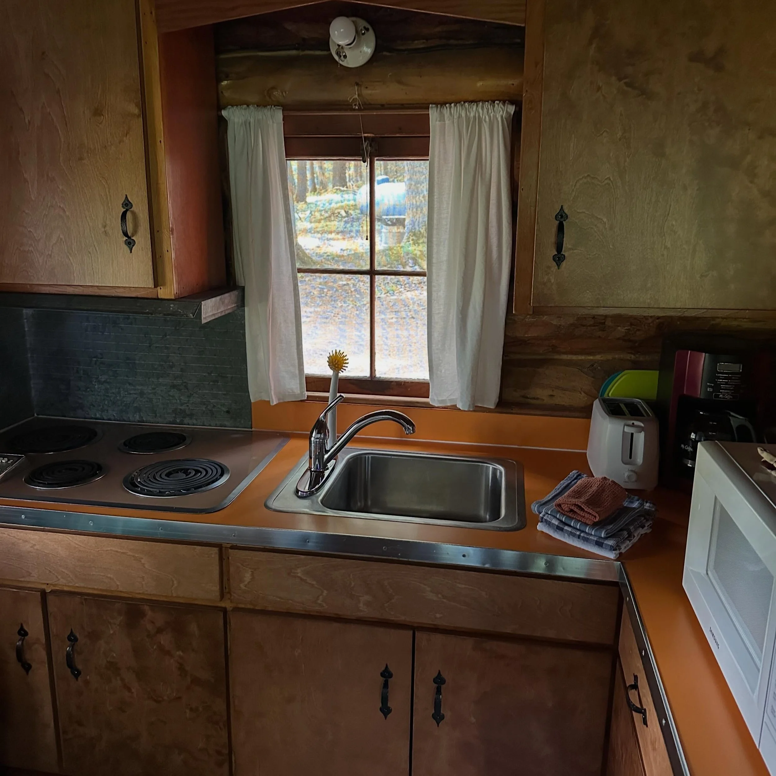 Beautiful refaced kitchen cabinets in the Nelj&auml; (No. 4) cabin, including a new silverware and utensil drawer. Perfect. manninenscabins.com #neljacabin #otterlakelife #manninenscabins