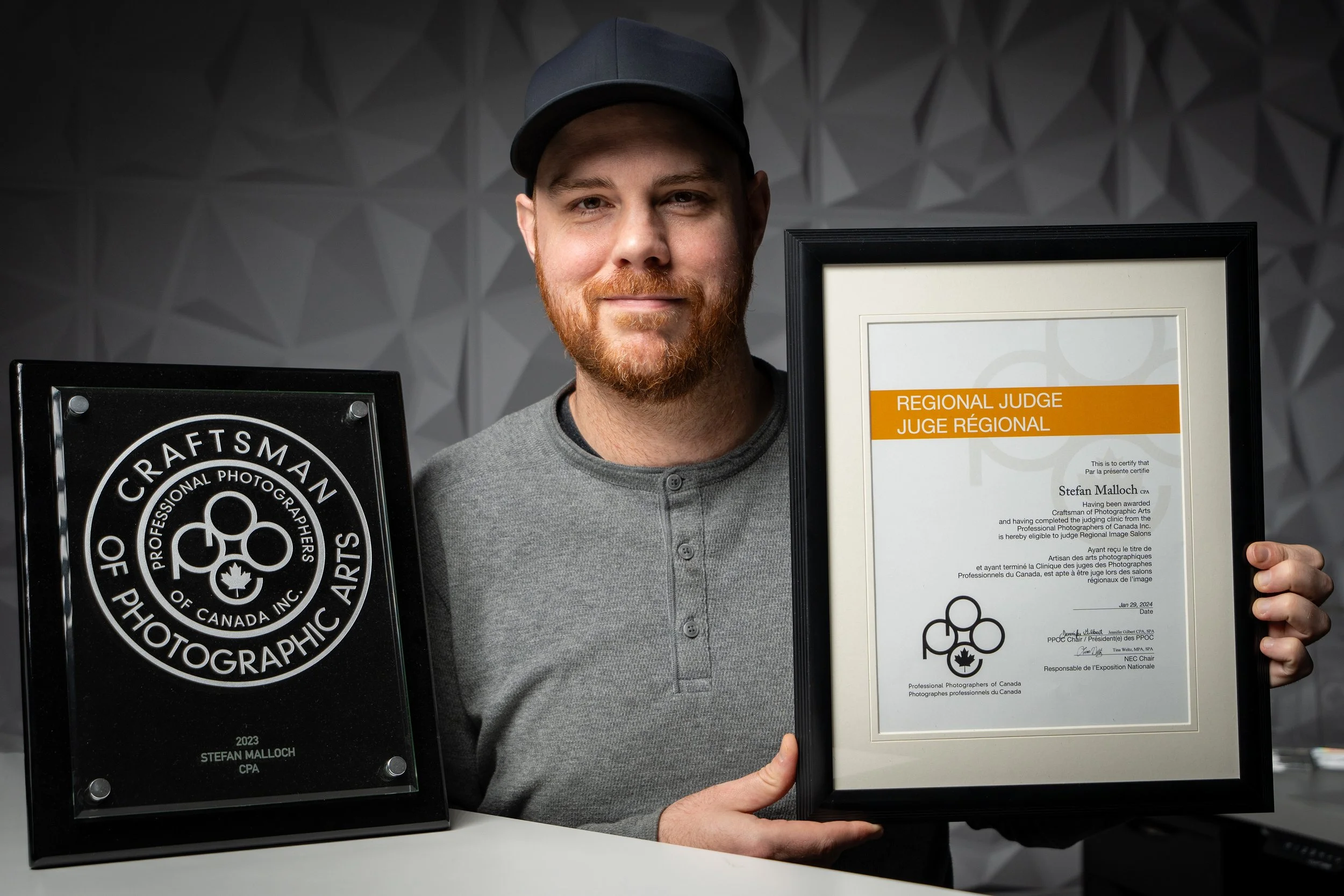 Stefan Malloch with his Craftsman of Photographic Arts plaque and PPOC regional judging certificate.