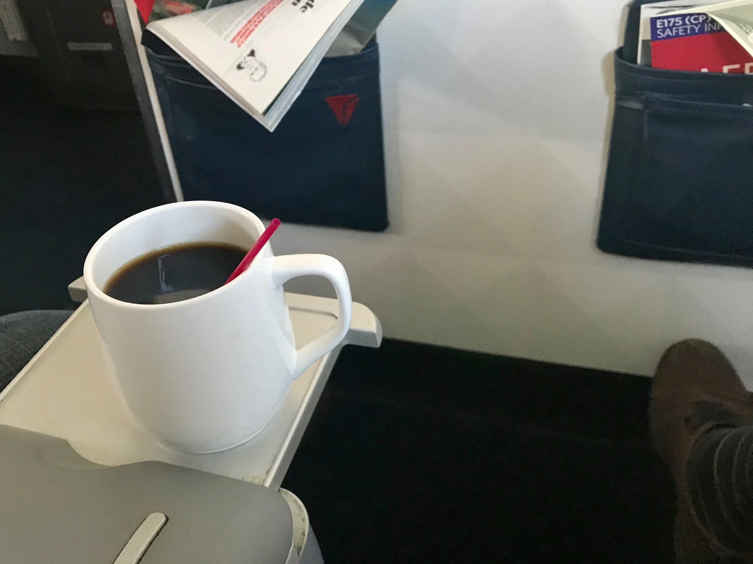 Seat 1D has a shared slide-out drink holder.