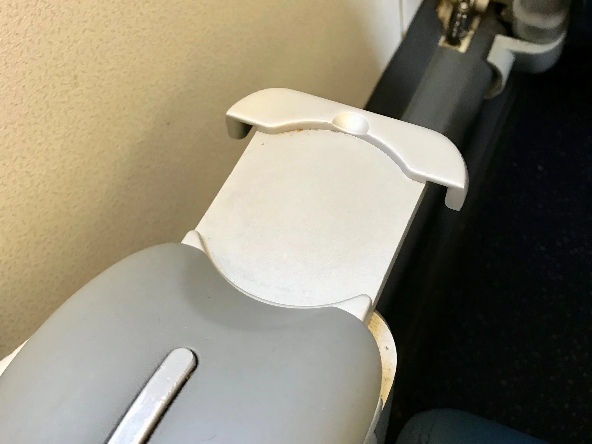 Seat 2A has a slide-out drink holder.