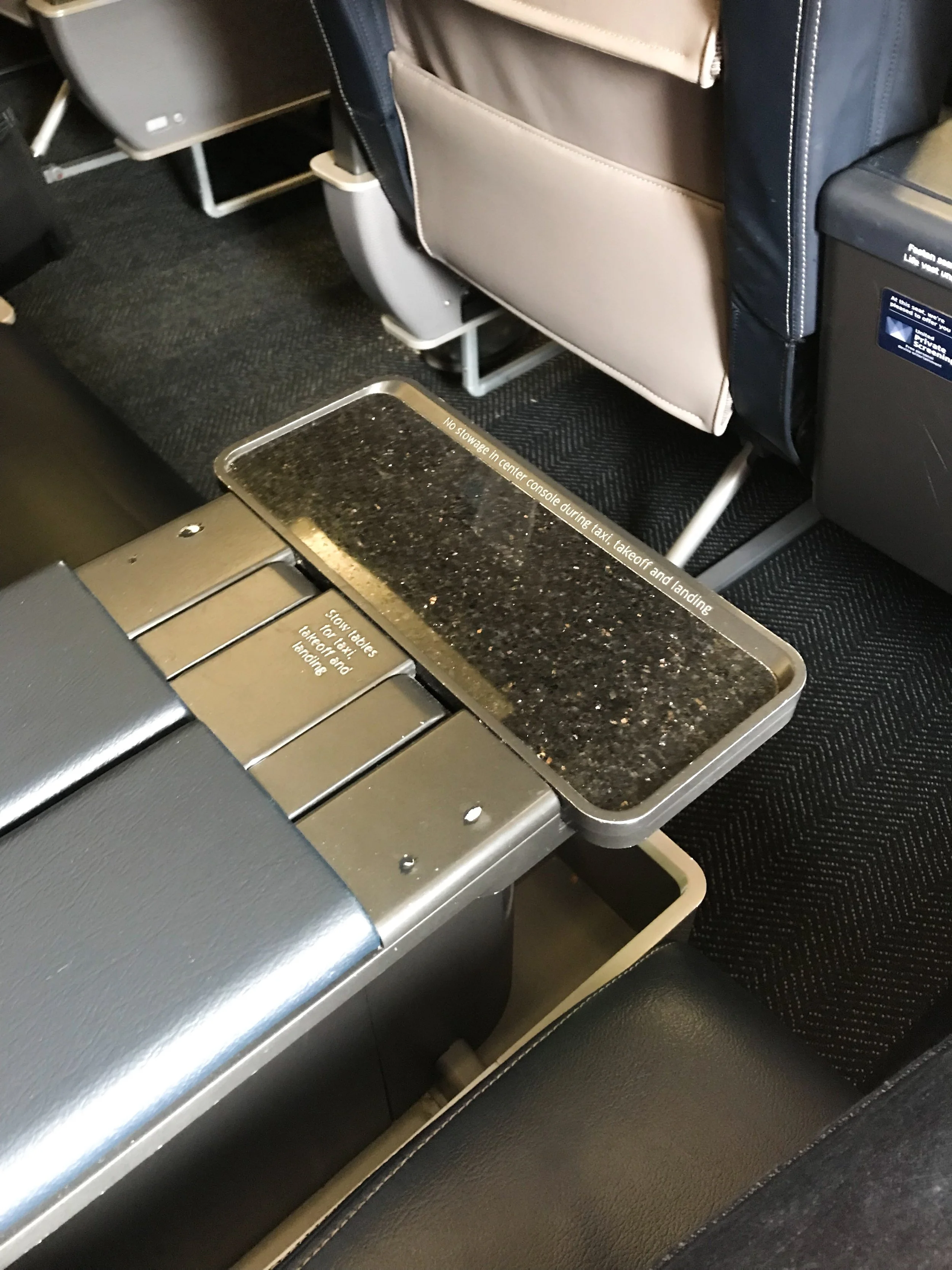 Each seat has a small granite (it felt and sounded like real stone) table for drinks.