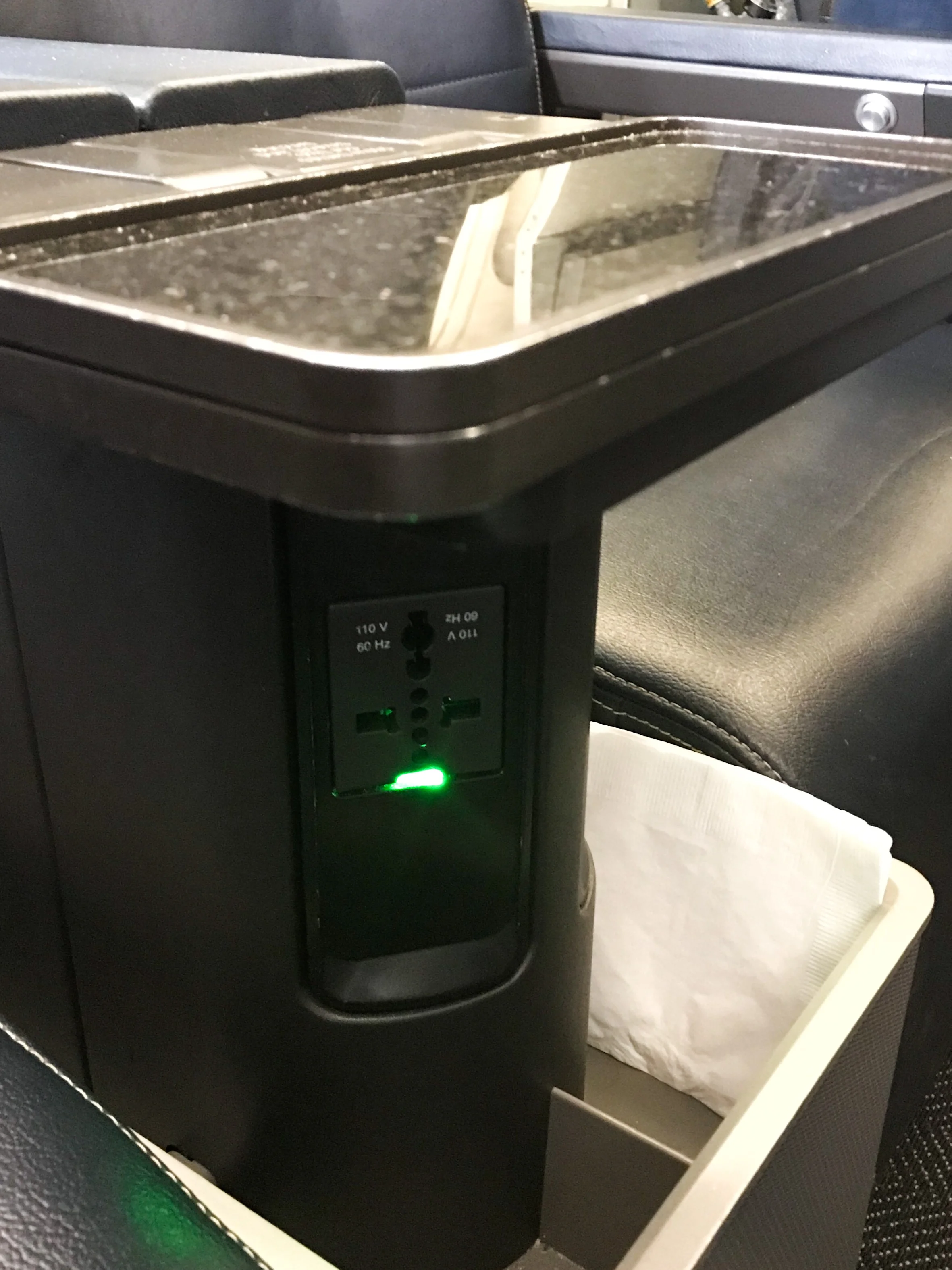 Each seat also features a small storage bin and universal power adapter. I couldn’t find any USB charging ports however.