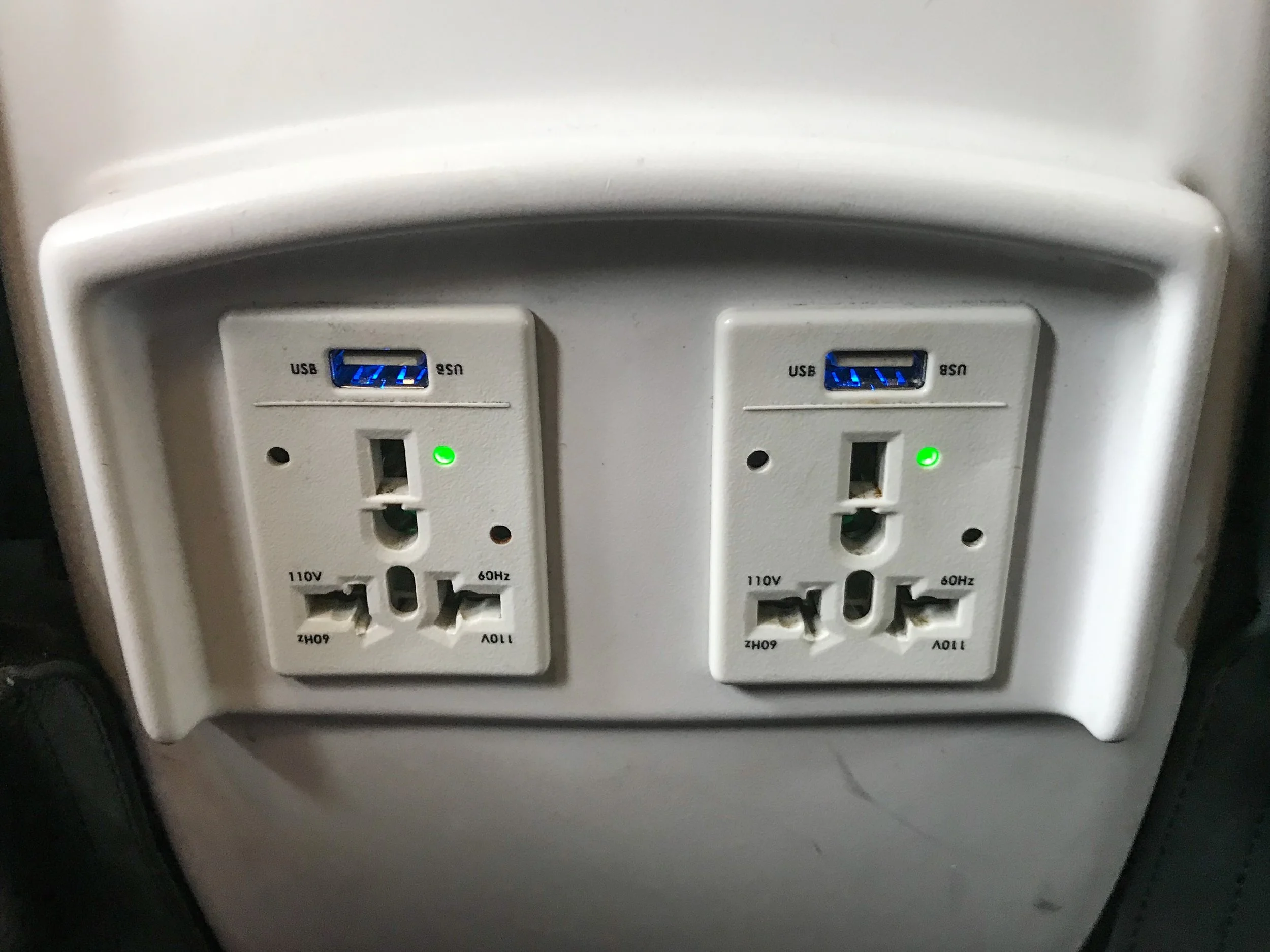 There are two 110V universal style power outlets and USB power ports for three seats in Row 6.