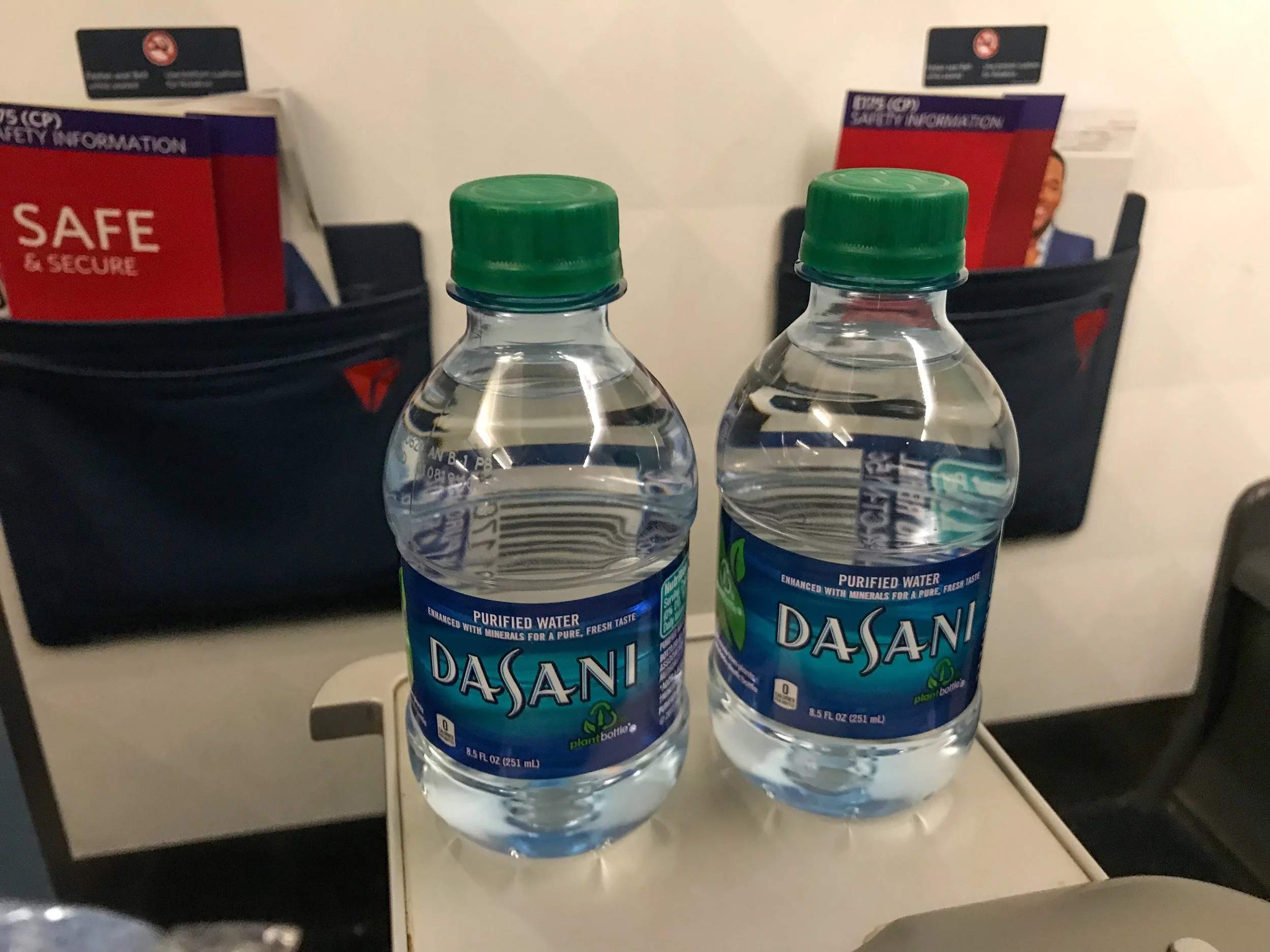 First Class passengers are provided Dasani water bottles, in addition to pre-departure beverage service (both alcoholic and non-alcoholic). Though, due to the delay, pre-departure service was suspended on this flight in order to expedite departure.