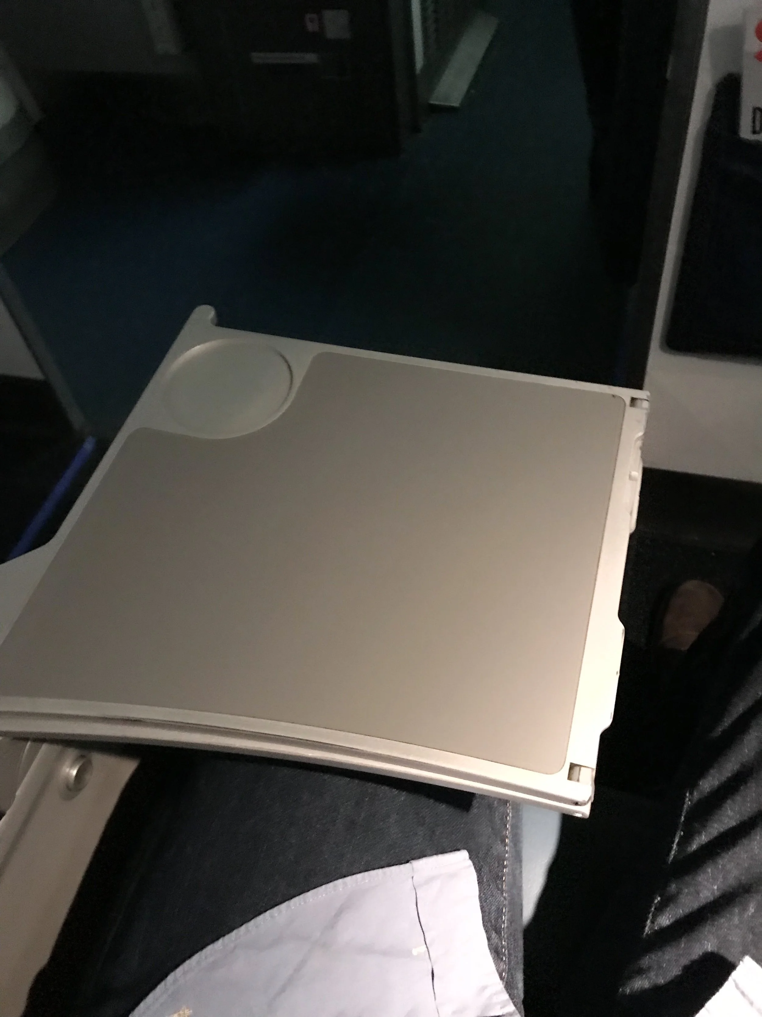 The tray table folds out of the armrest.