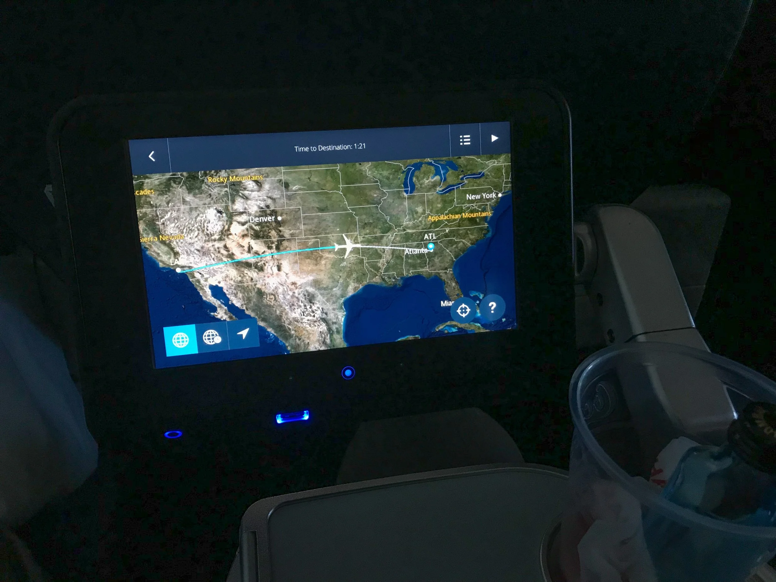 The IFE screen pulls out from under the seat in Row 15. There is also a USB charging port on the screen.