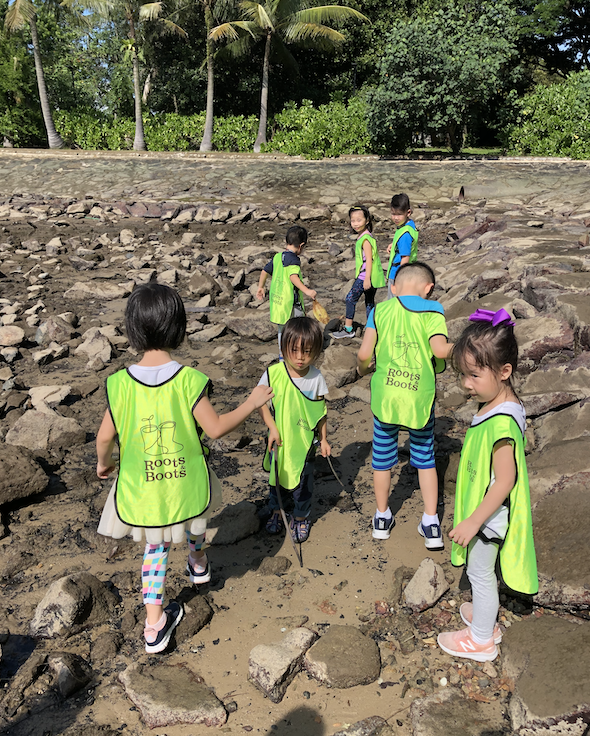Exploring a mudflat during low tide. At the same time, helping to collect trash.