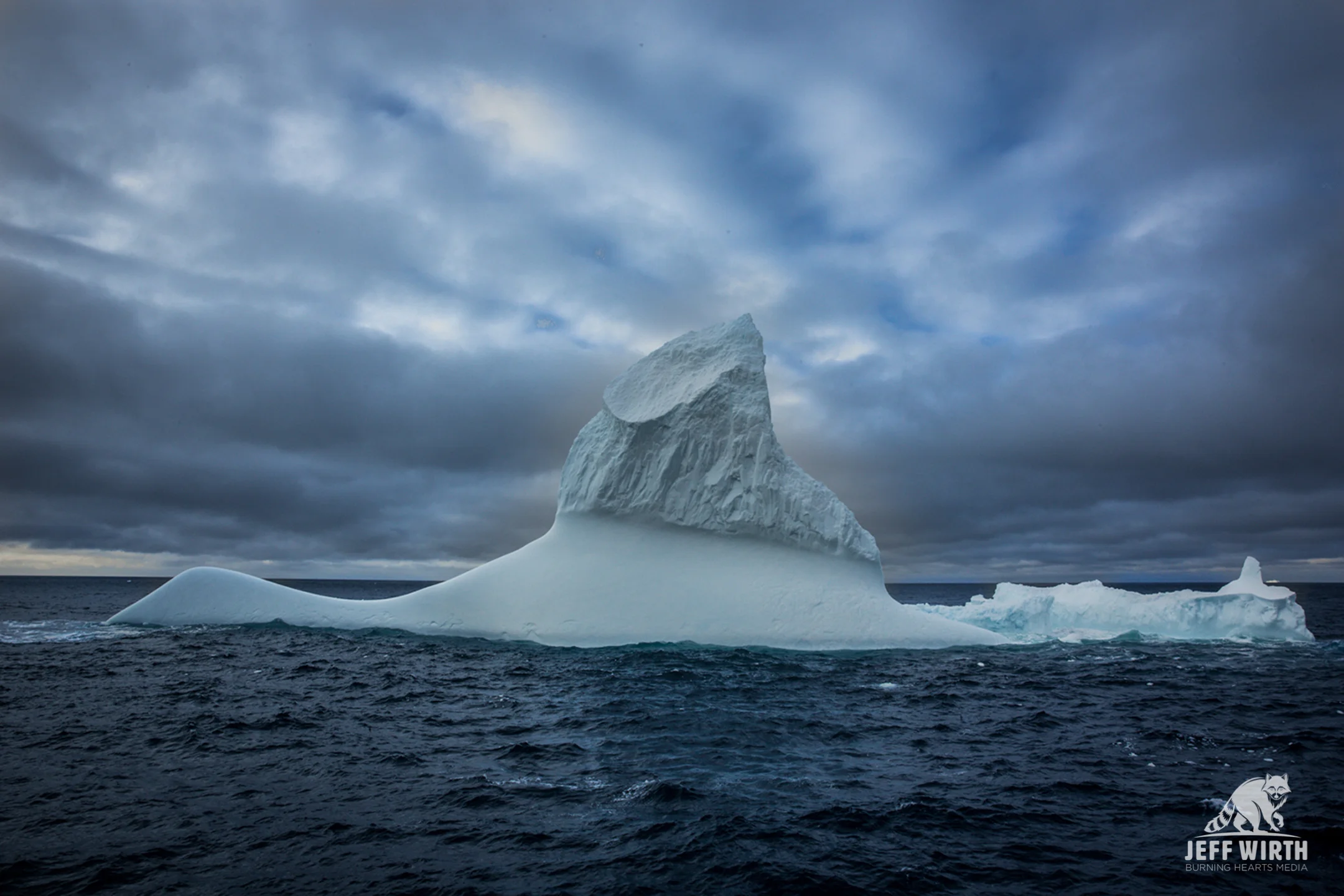 A massive iceberg with a beautiful Antarctic sky.