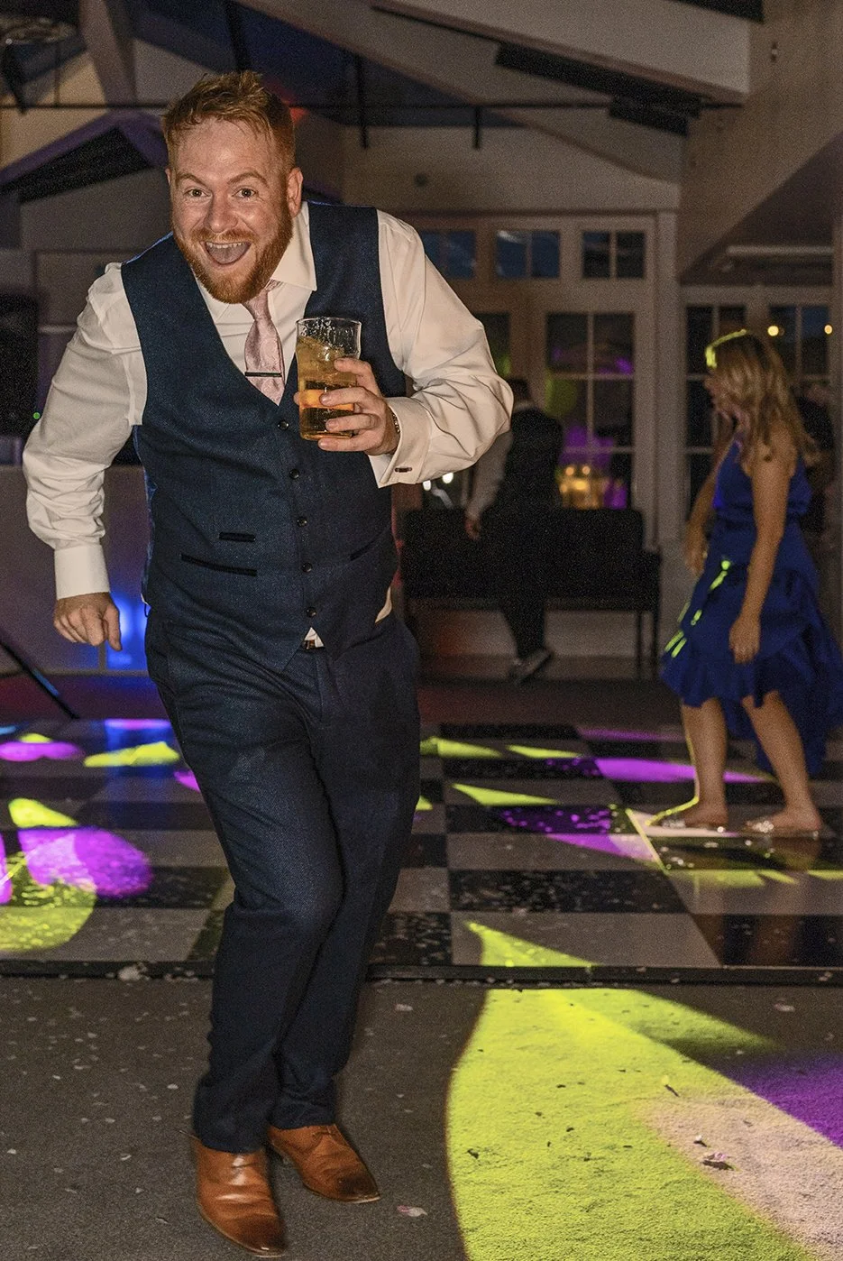 Wedding guest dancing captured in a documentary candid style by the photographert