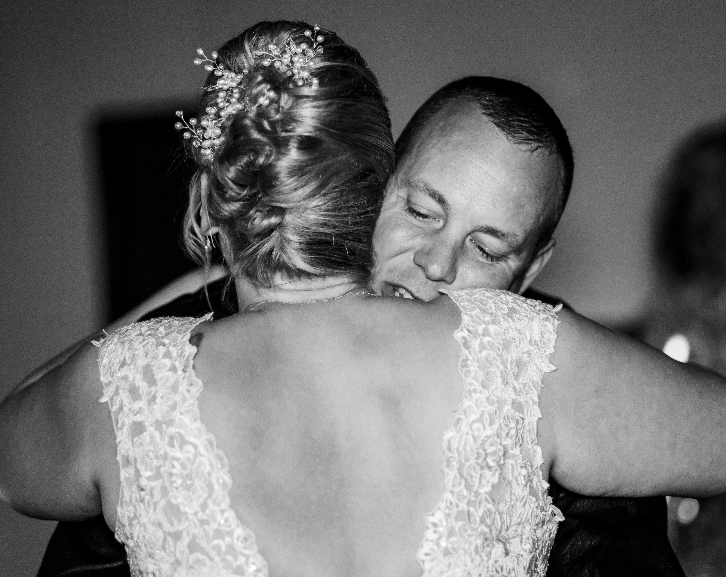 Intimate moment of a bride and close relative captured in a candid style 