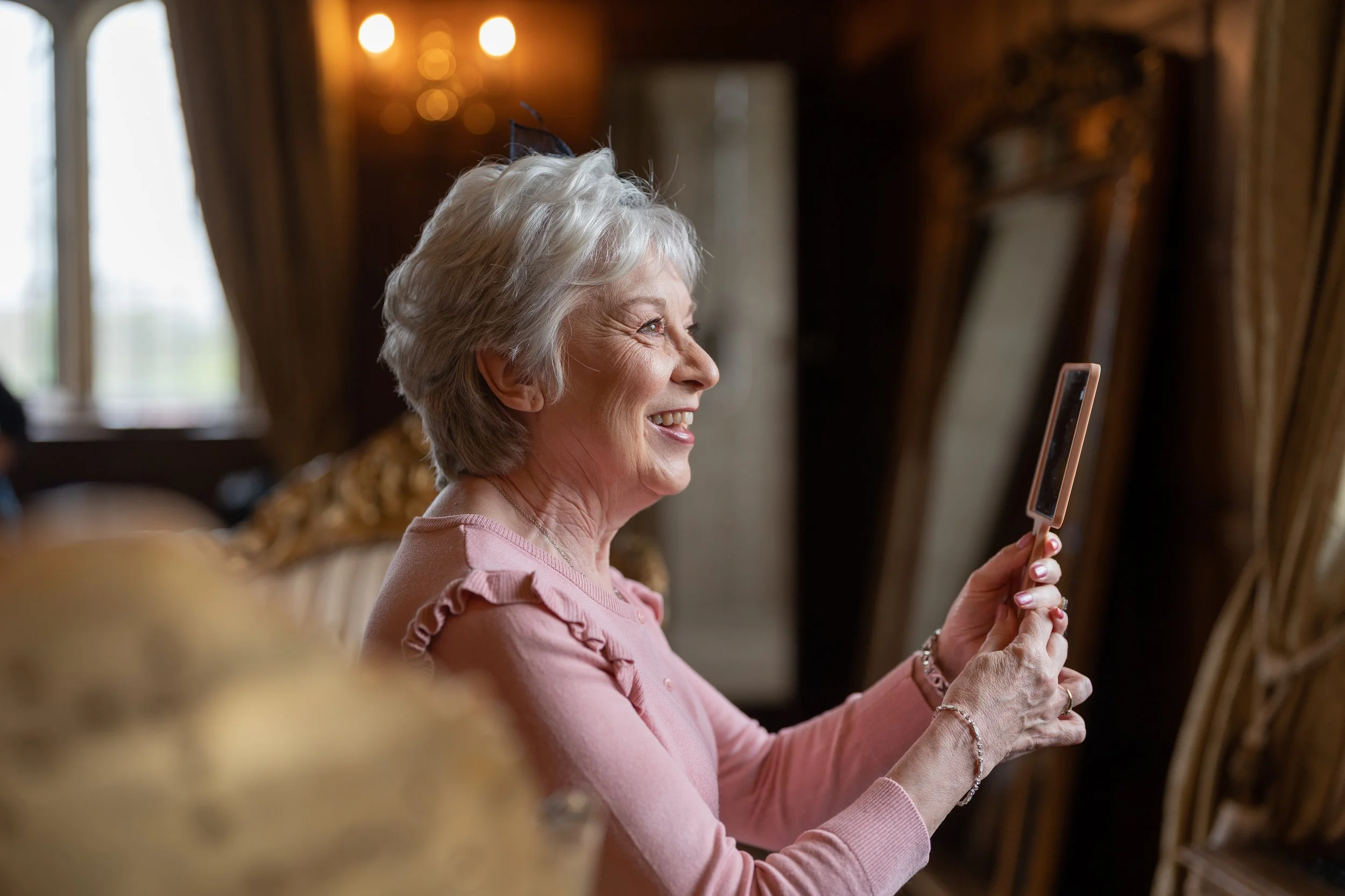 Mother of the bride getting ready, wedding photography capturing preparation