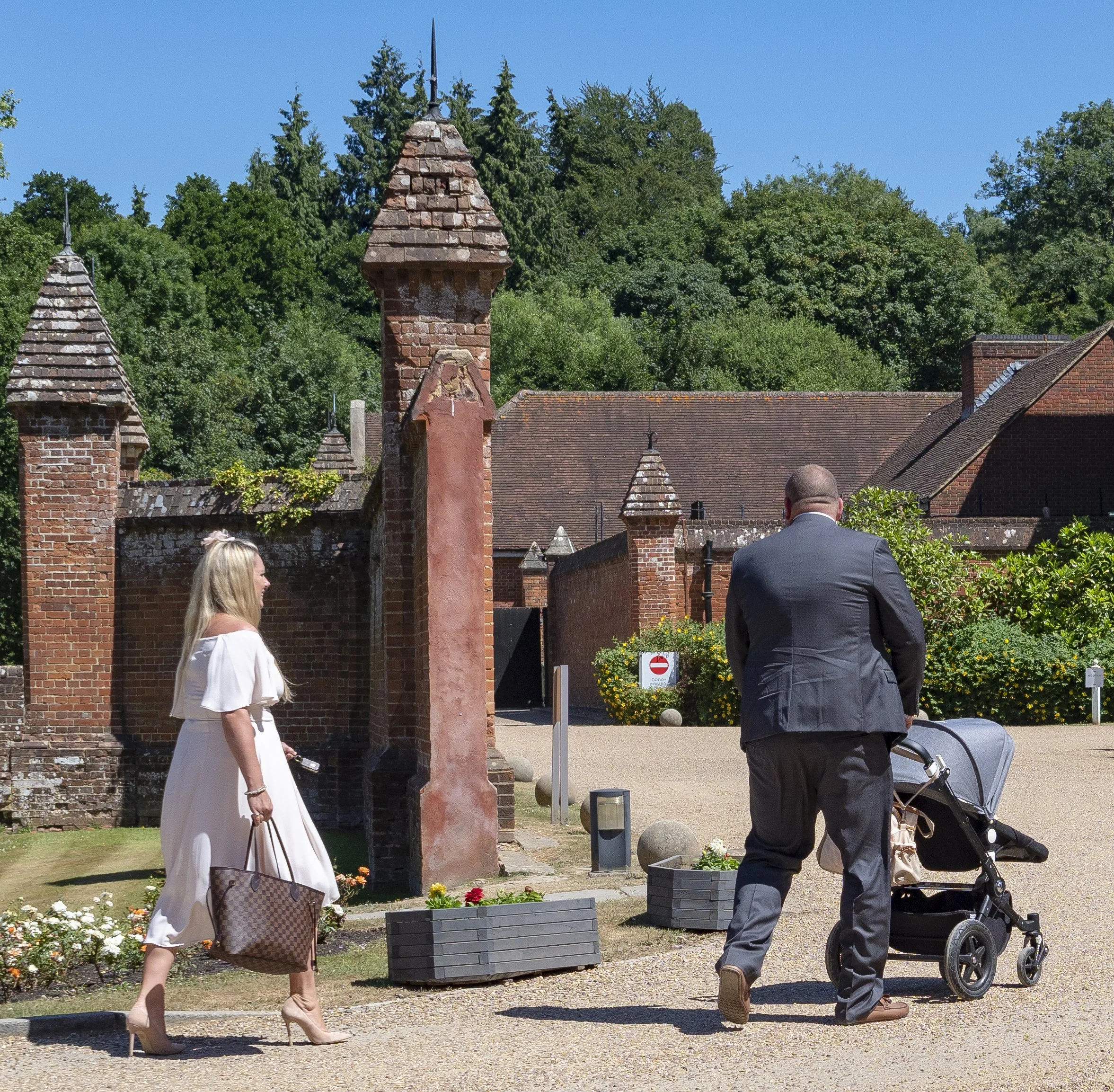 Wedding guests photographed in a candid documentary style arriving at the venue