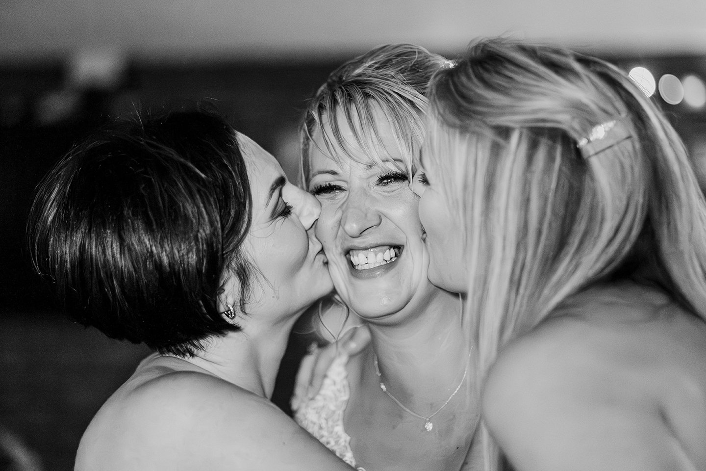 Bride and maids of honour in an intimate moment at a wedding