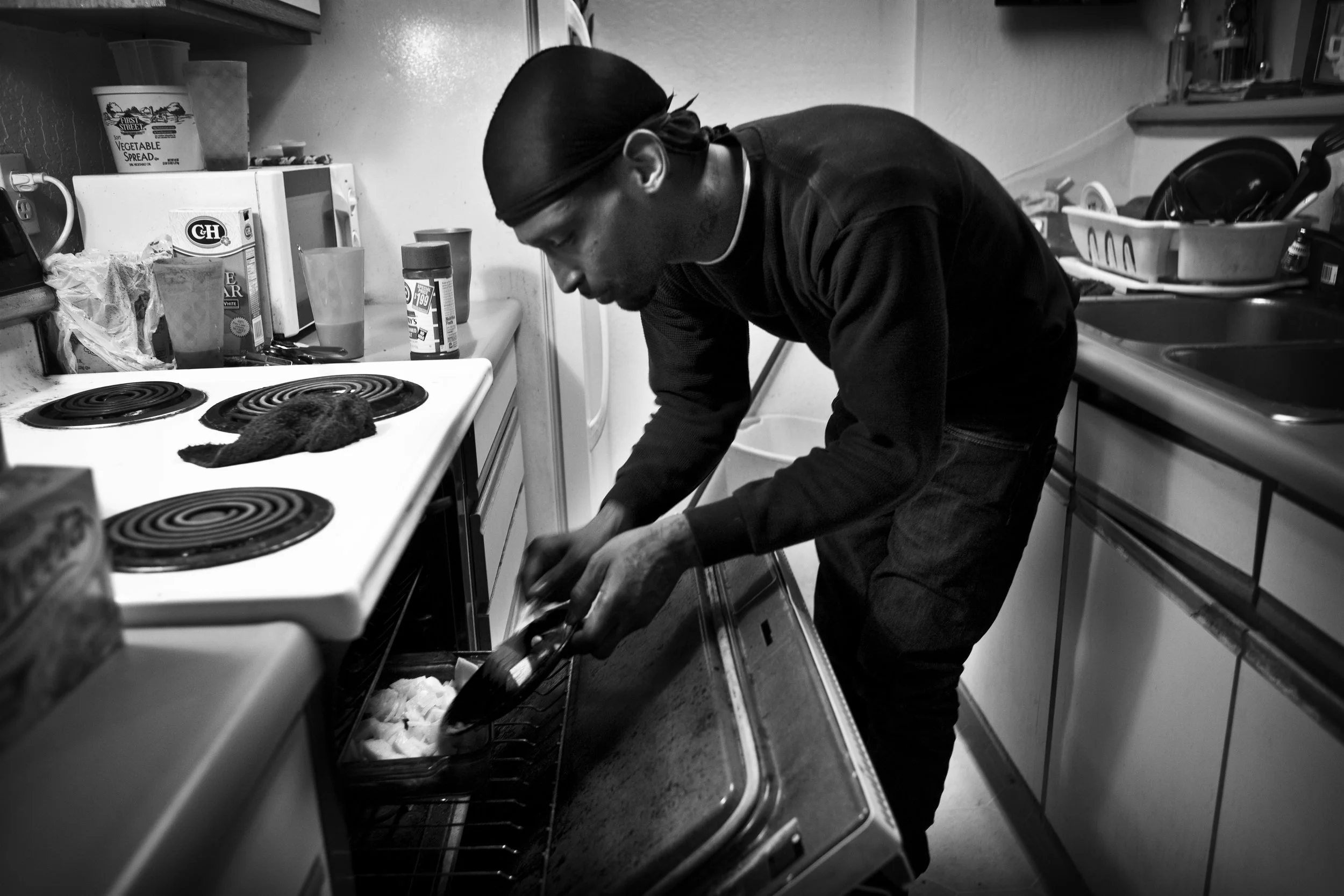  Shanon prepares a meal in an apartment in downtown Oakland. 
