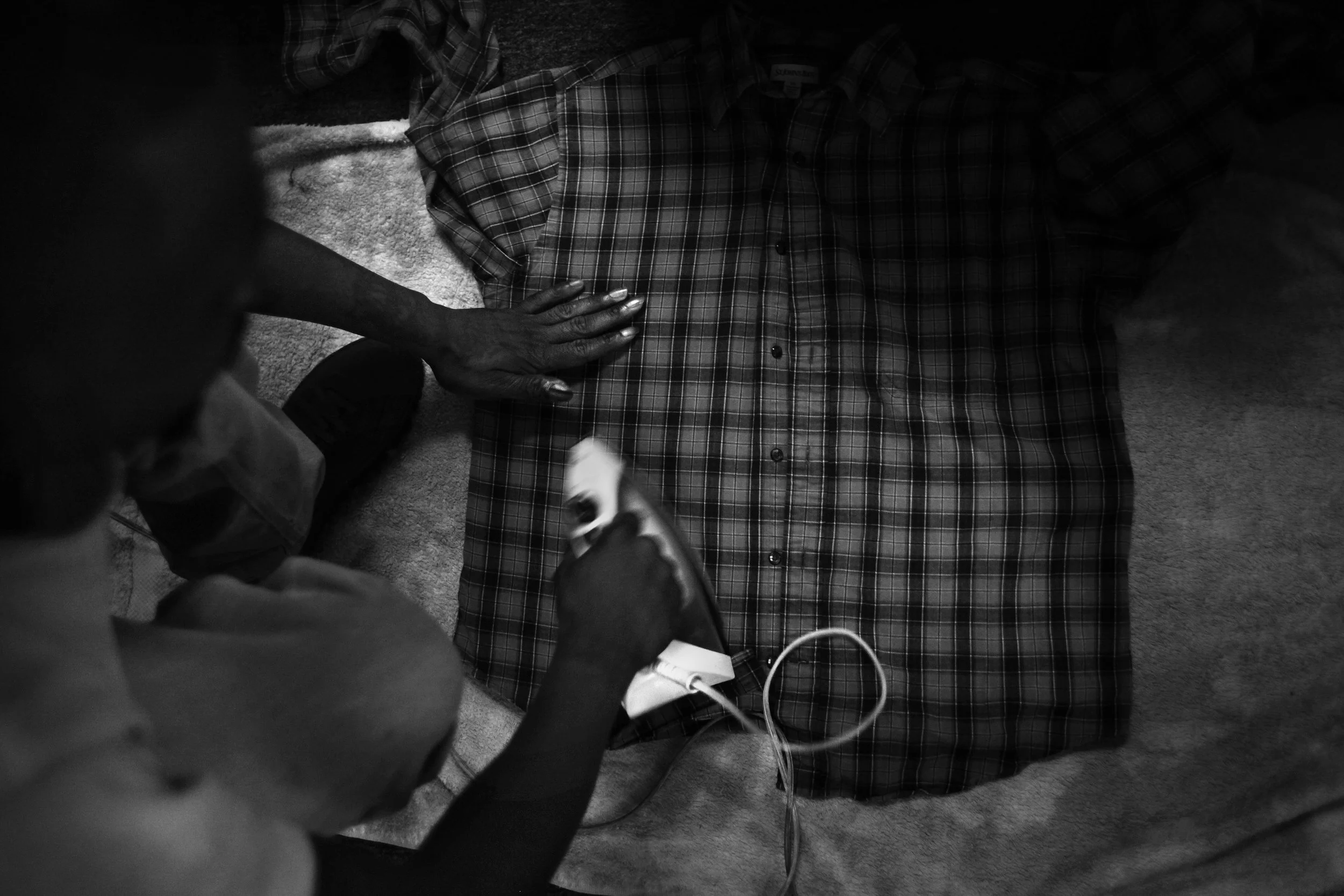  Shanon irons a shirt in preparation for a job interview. 