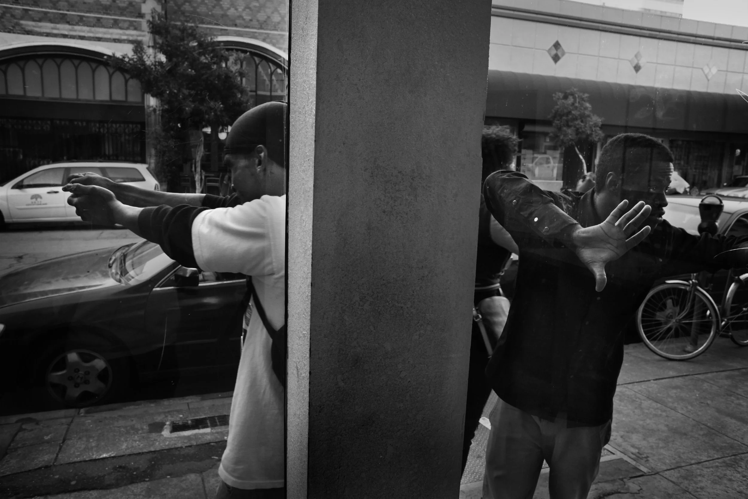  Shanon, left, mimics shooting a gun in downtown Oakland. 
