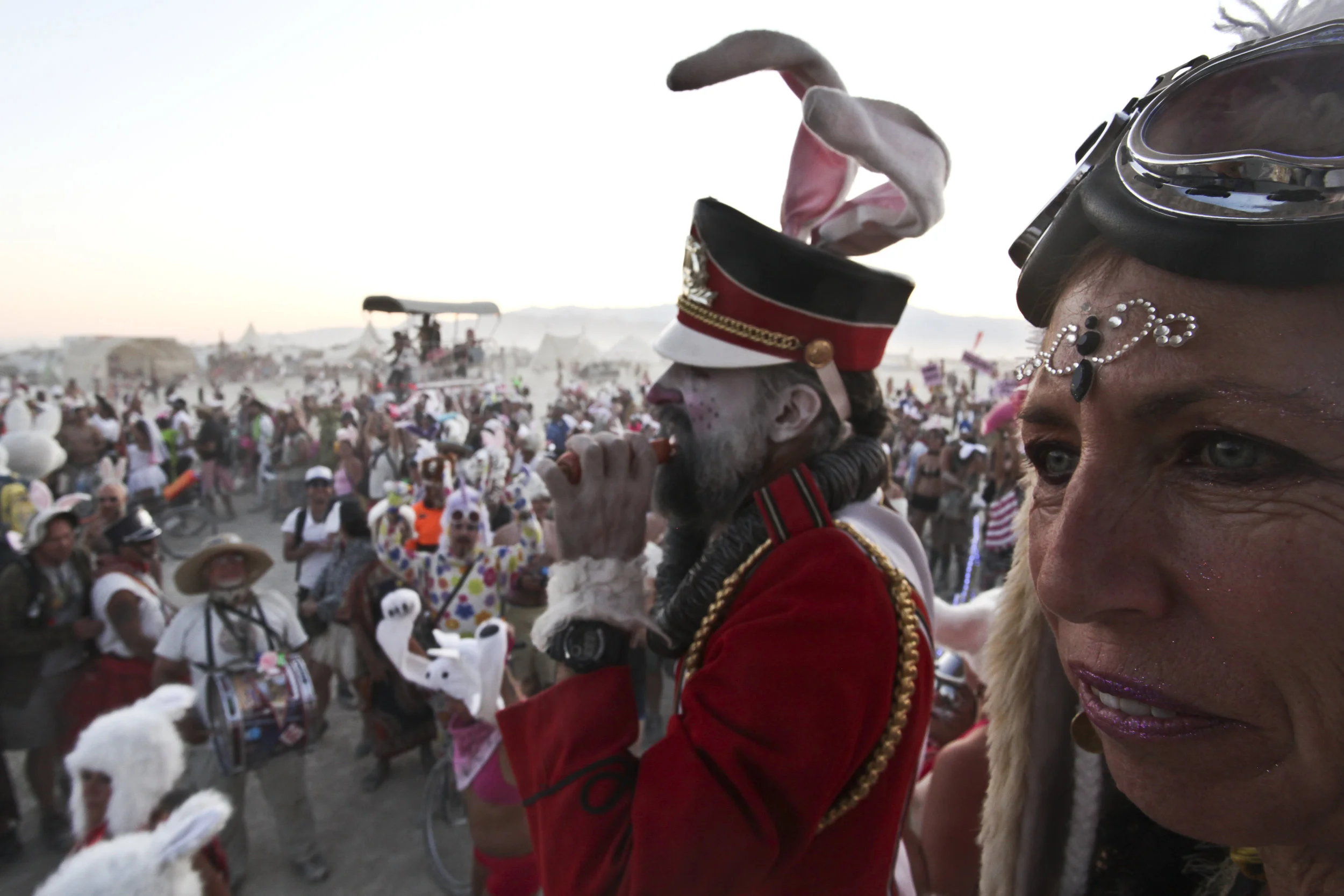  A man with a mega phone yells to the crowds of bunnies during a march. 
