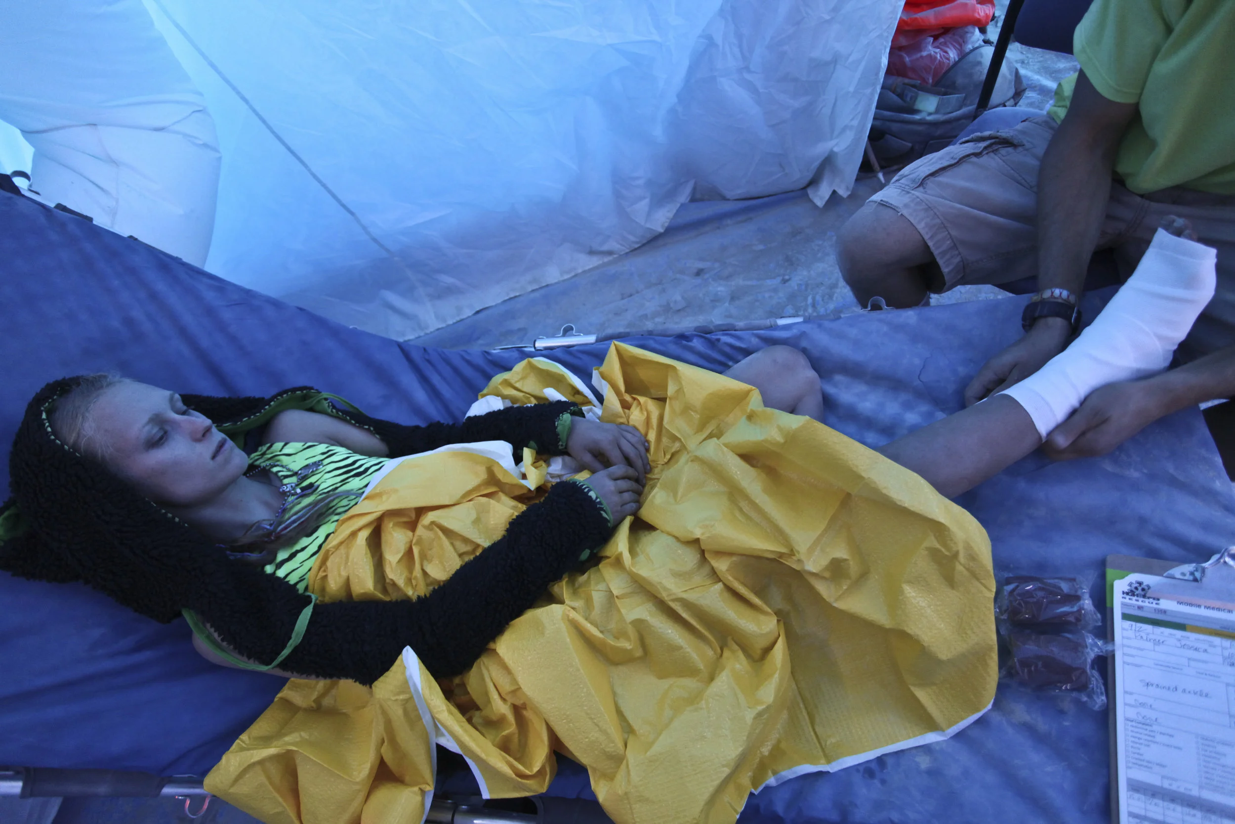 In the medical tent Princess Palmer gets her foot rapped up by Mike Seopa a first year Burning Man EMT. Palmer fell off an art car earlier in the day. 