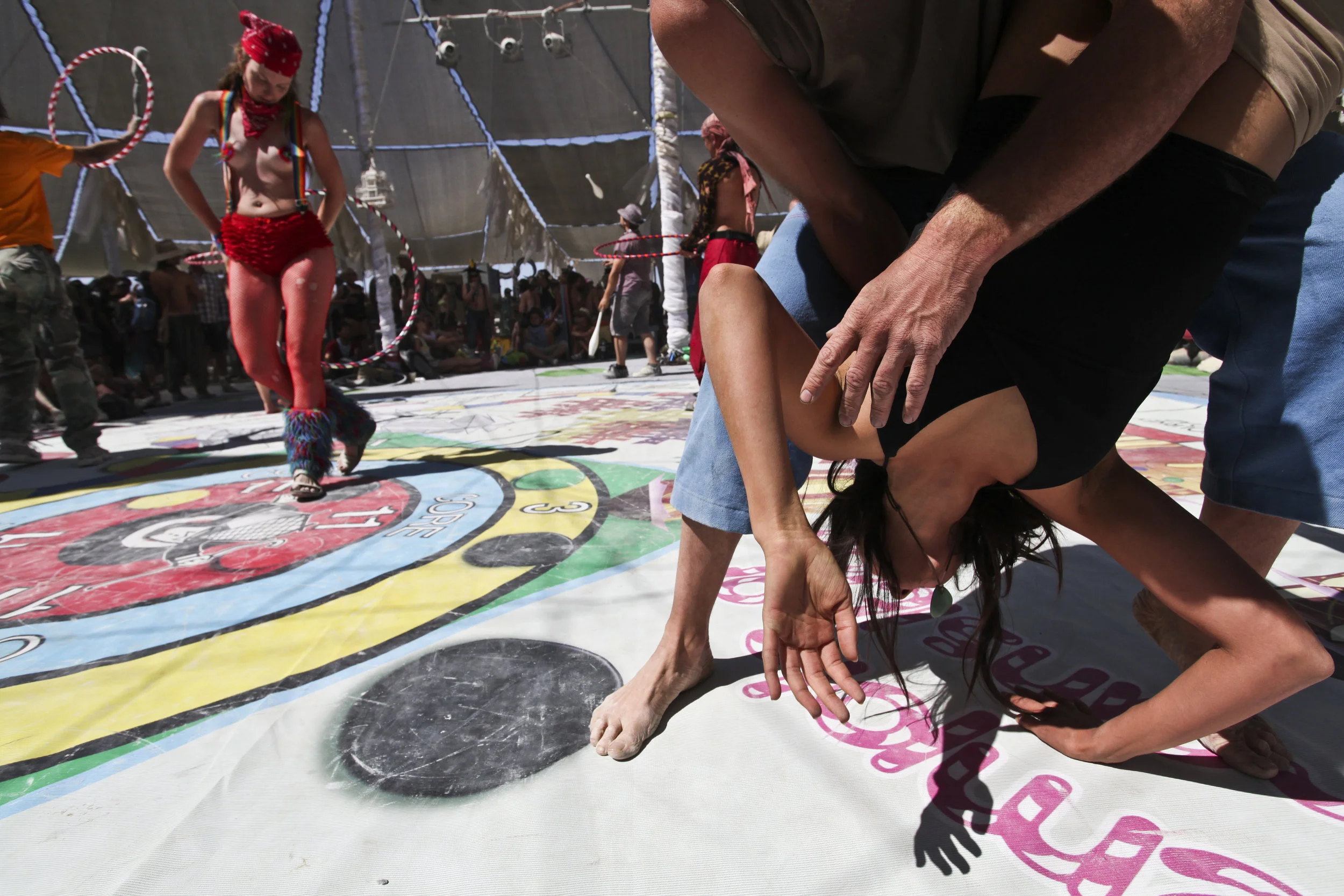  Two people perform a type of dance yoga in center camp, an area that is always open 24 hours a day, and that sells coffee, displays art and has two stages for constant performances. 