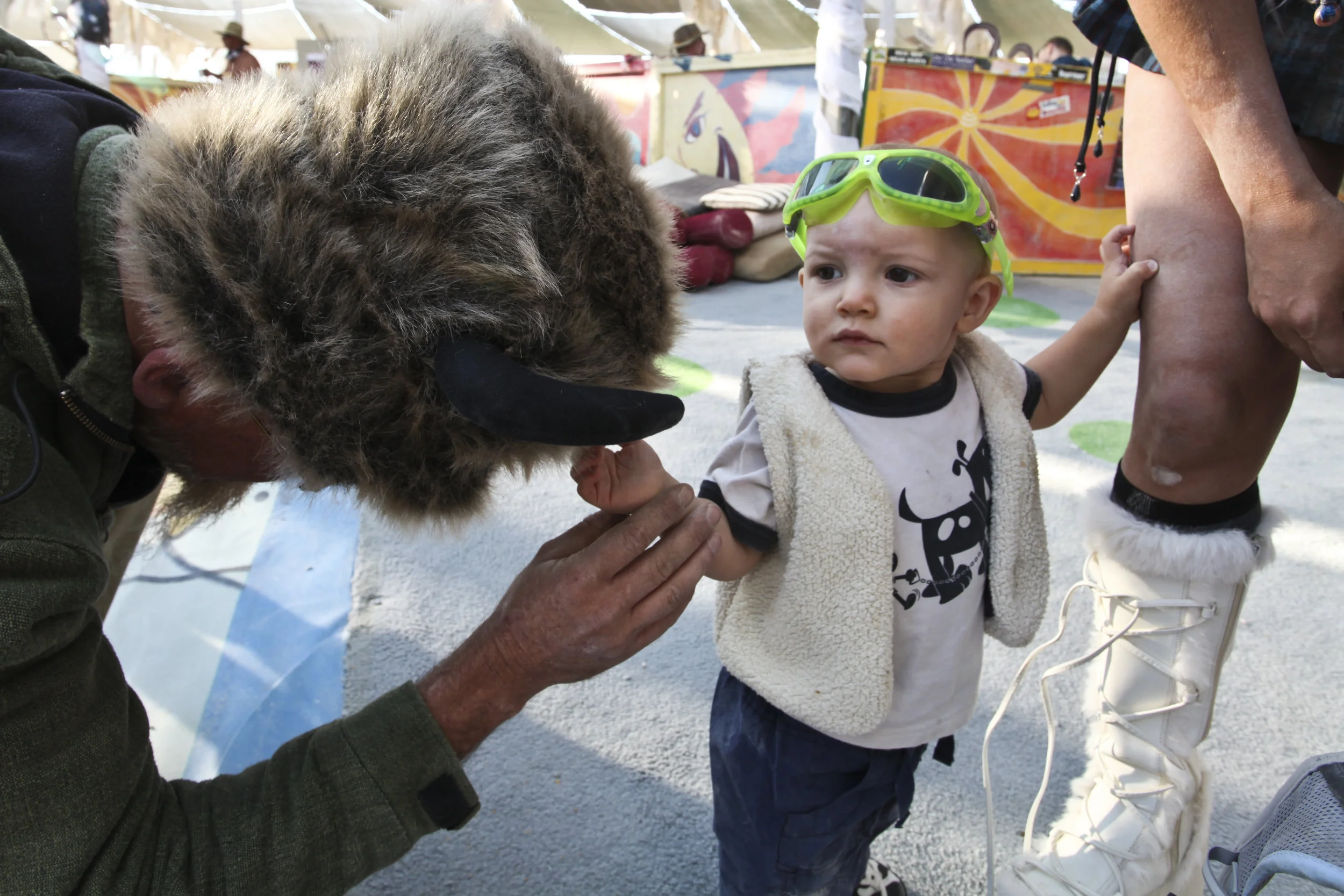  Jacks 2 years old touches a hat at Burning man. 