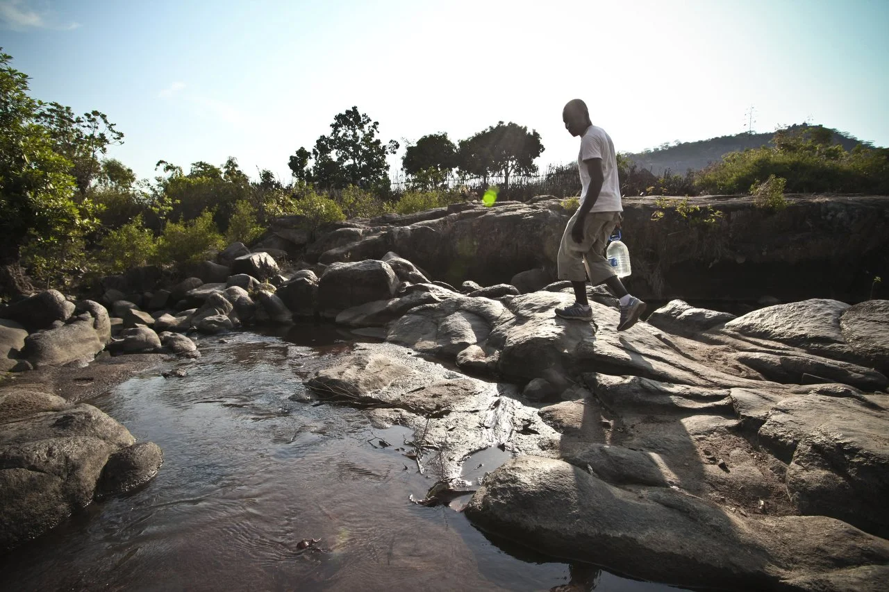  Reymond Mapakata gathers water from a river in his village, located in the region of Bakita in Zimbabwe. The village is about a 40 minute hike from the closest shops. Thousands of Zimbabwean refugees crossed the border to South Africa to escape poli