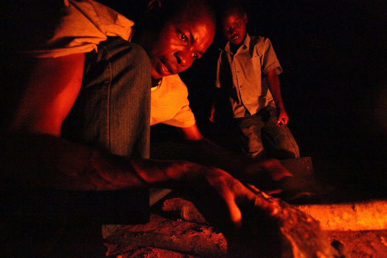  People make fire at night in a village, located in the region of Bakita in Zimbabwe. The village is about a 40 minute hike from the closest shops. Thousands of Zimbabwean refugees crossed the border to South Africa to escape political turmoil, lack 