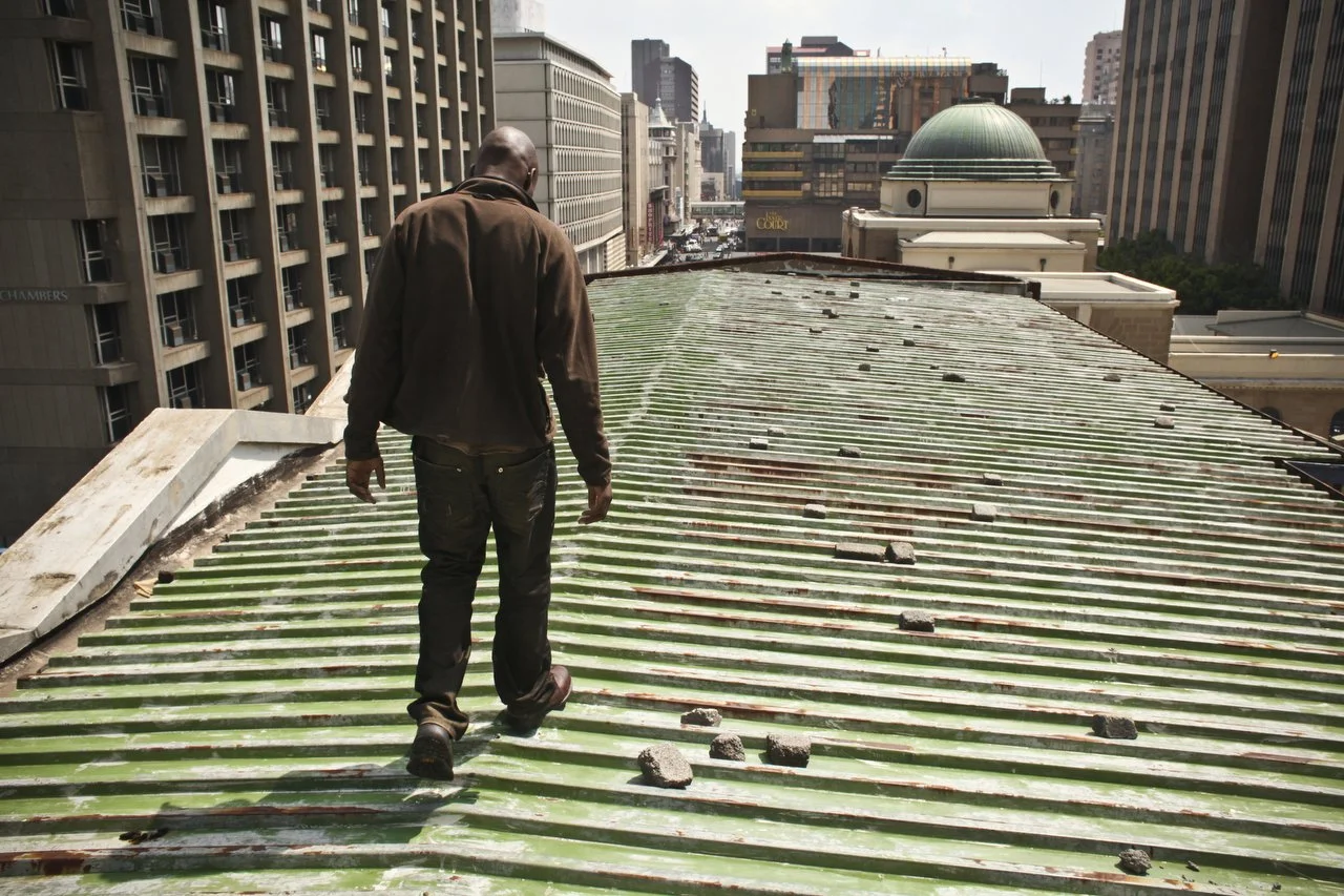  Reymond Mapakata walks on the roof of the Central Methodist Church in Johannesburg South Africa. The church has an official capacity of 1,500 people. At night, more than 2,000 patrons occupy every floor space available. The church has been a sanctua