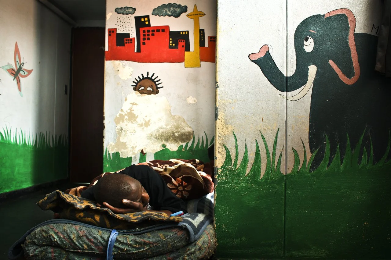  A man takes a nap in the medical room of the Central Methodist Church in Johannesburg South Africa. The church has an official capacity of 1,500 people. At night, more than 2,000 patrons occupy every floor space available. The church has been a sanc