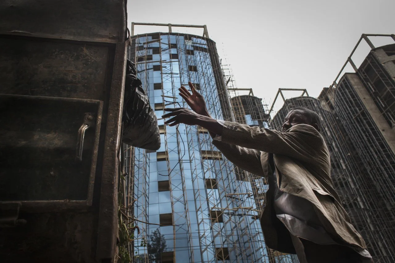  A private trash collection agency picks up trash throughout Nairobi on June 29th 2013. From glue-addicted street boys, who go door to door looking for dead electronics, to foreigners who come into the slums for the business opportunity, the e-waste 