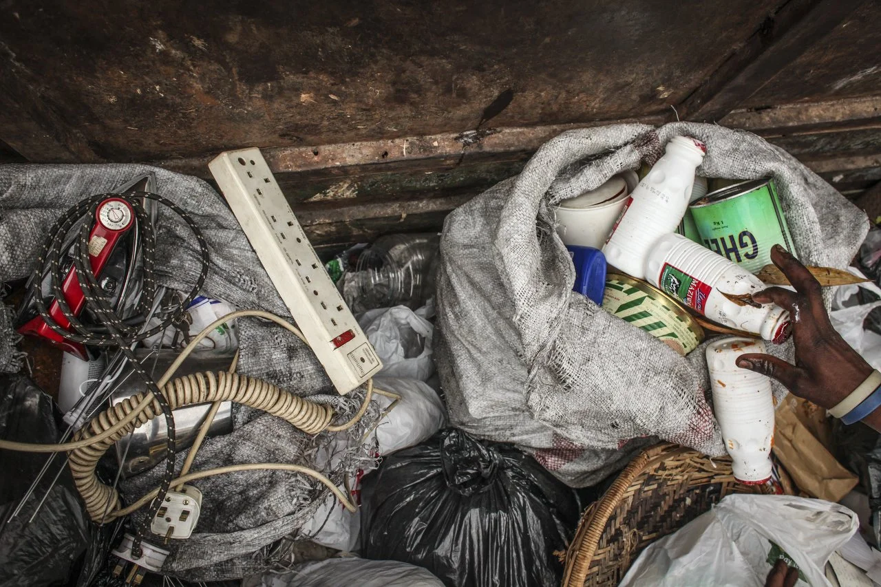  A private trash collection agency organizes trash in the back of the truck during a trash pickup run in Nairobi on June 29th 2013.  