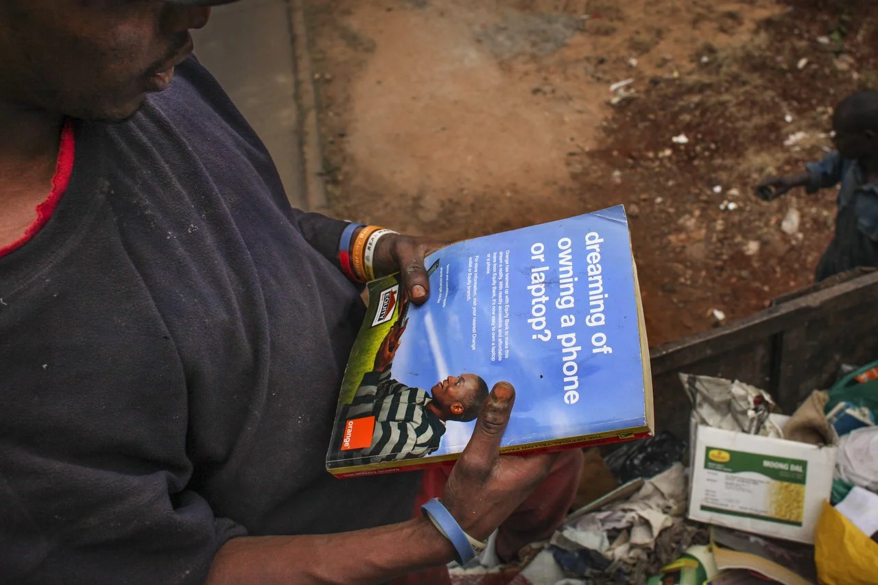  A private trash collection agency organizes trash in the back of the truck during a trash pickup run in Nairobi on June 29th 2013.  
