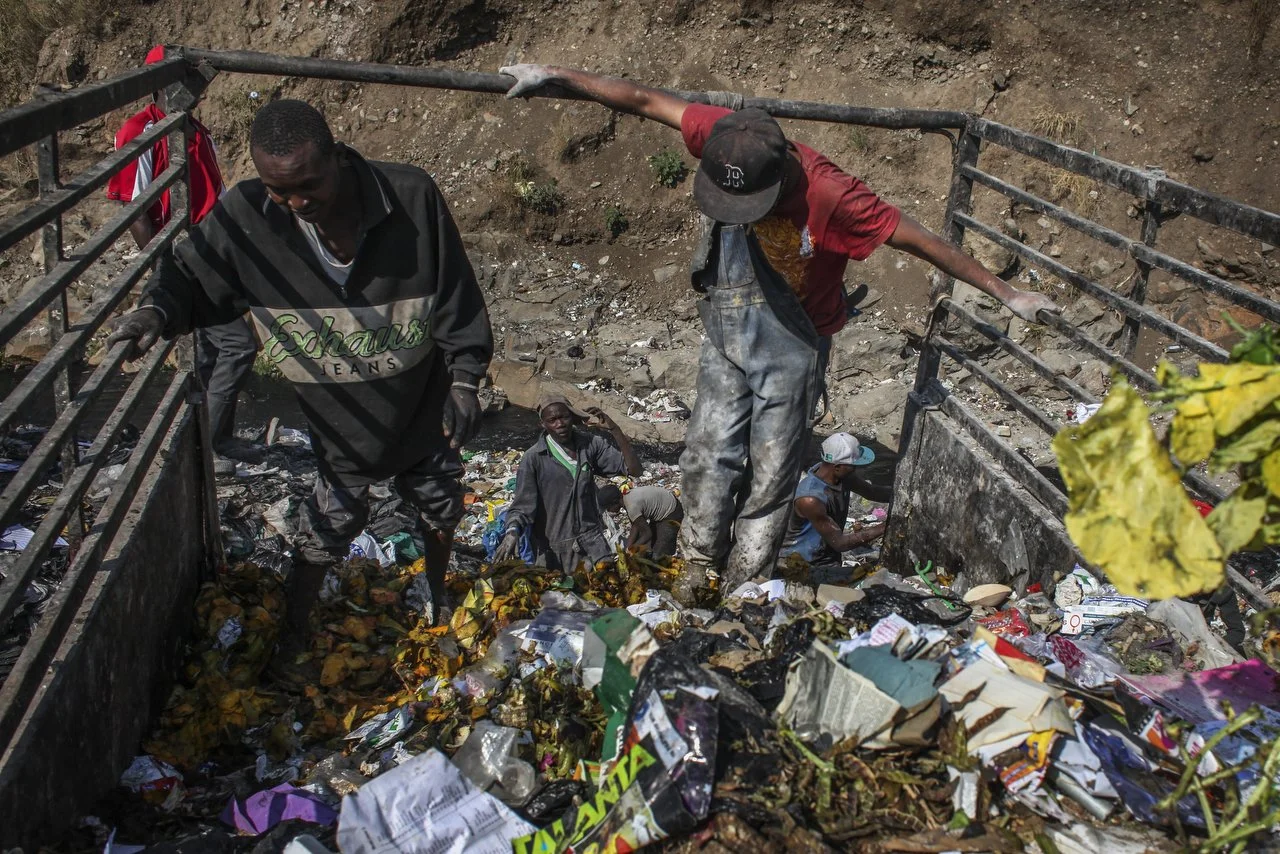  A private trash collection agency collects trash during a trash pickup run in Nairobi on June 29th 2013.  