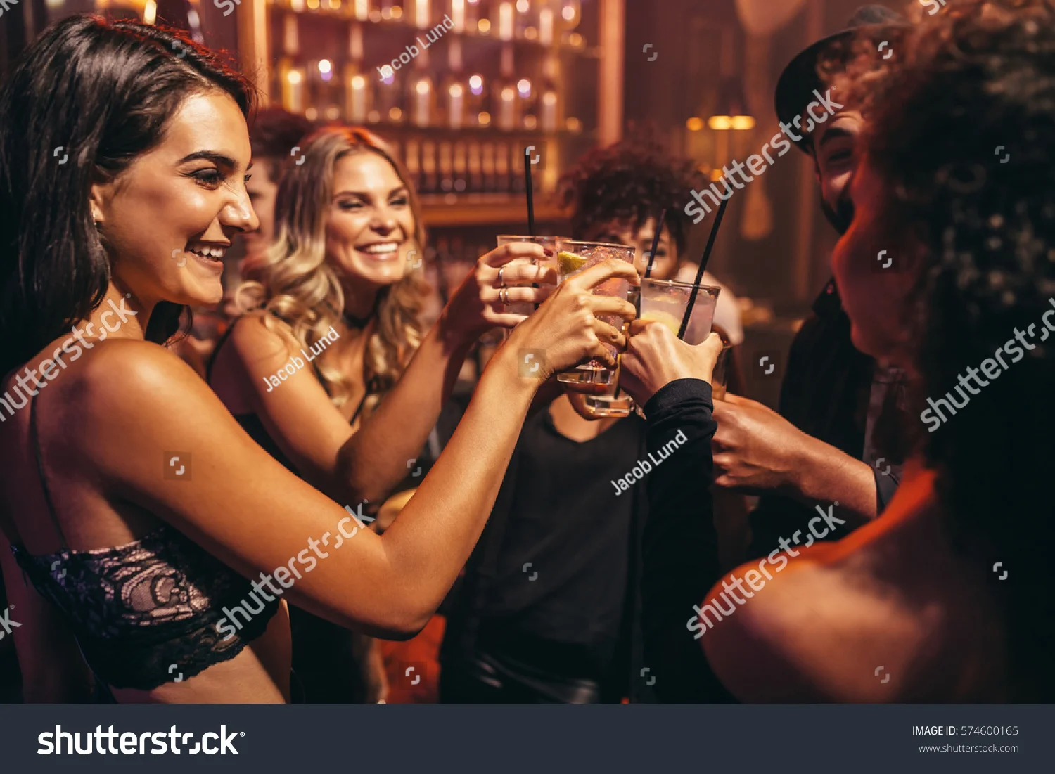 stock-photo-group-of-young-people-with-cocktails-at-nightclub-best-friends-partying-in-a-pub-and-toasting-574600165.jpg