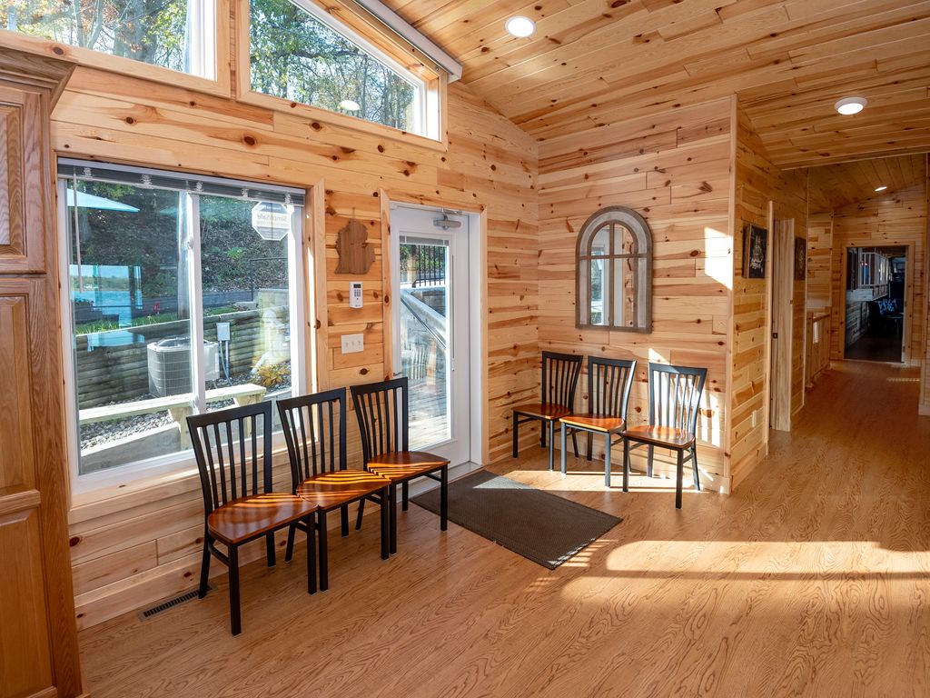 Extra dining chairs flank front entrance. Behind mirror is the 12th full BA.