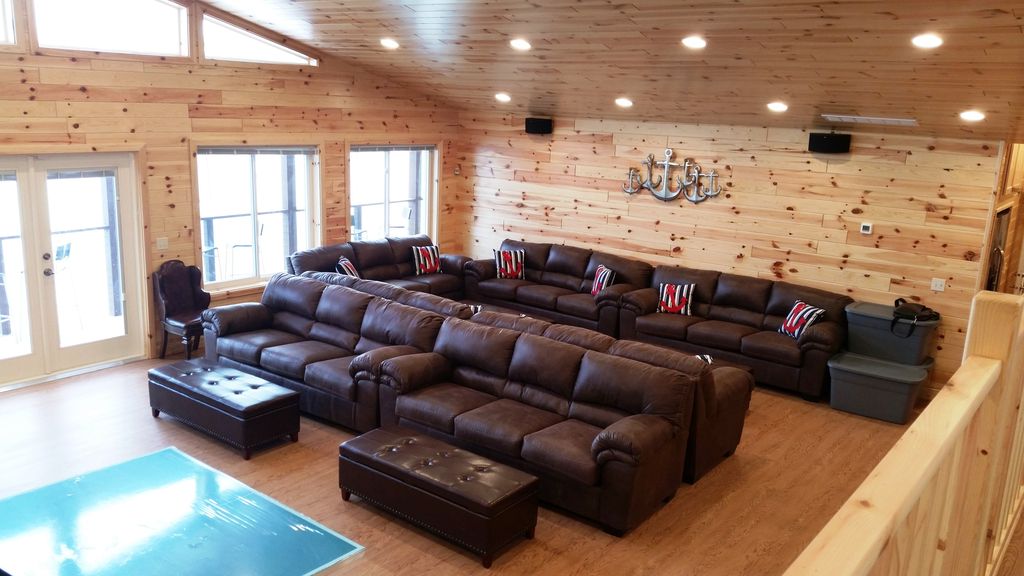 Gathering-Game Rm has 7 sofas, 4 ottomans. This view is from Kid's Play Loft.