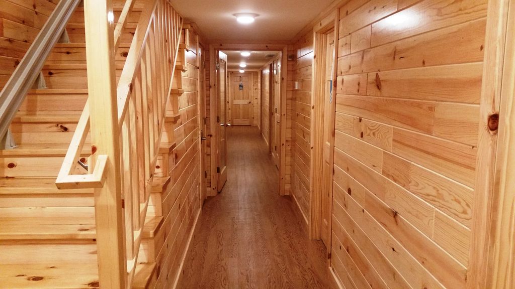 Walk-out level hallway leads to 6 BR-BA suites.