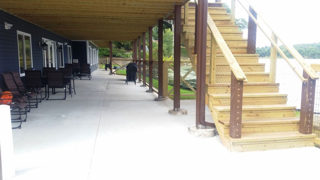 Patio has gas + charcoal grills. Fencing keeps little ones away from the lake.