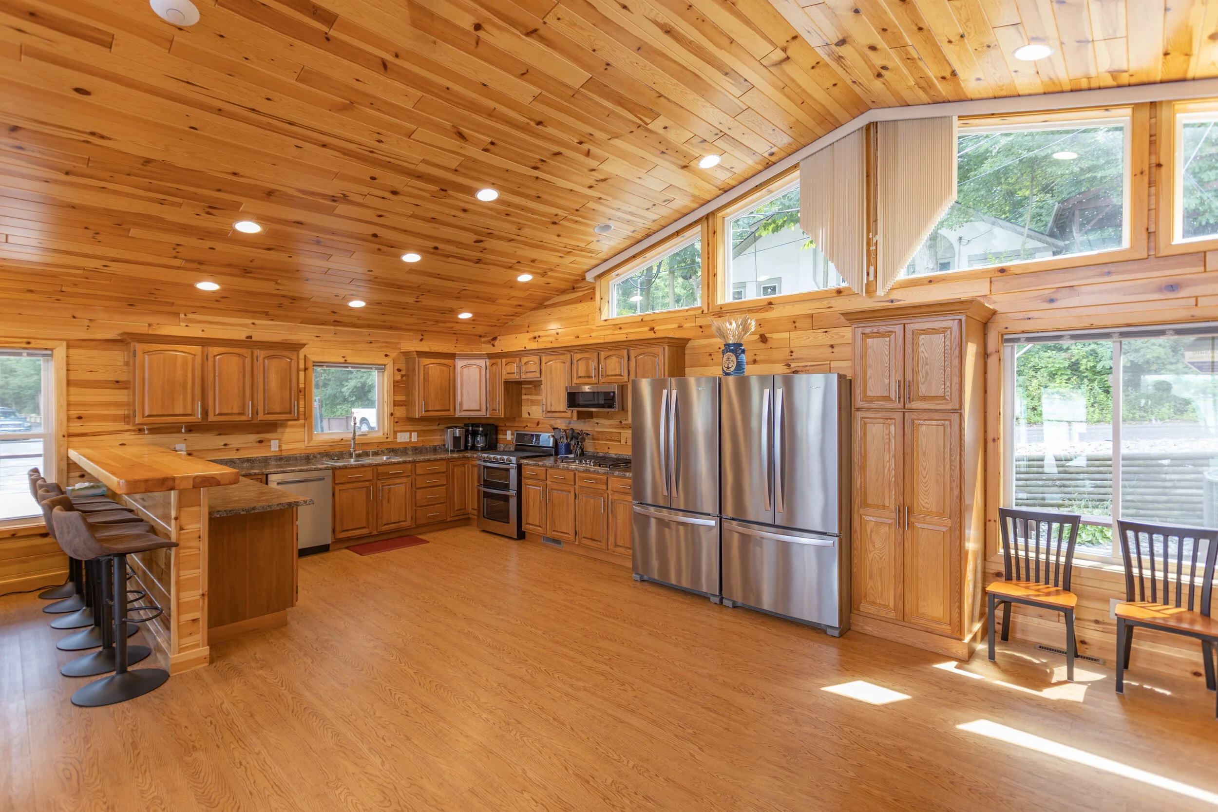 Kitchen has 2 fridges, 2 gas cooktops, 2 ovens, 2 dishwashers, microwave.