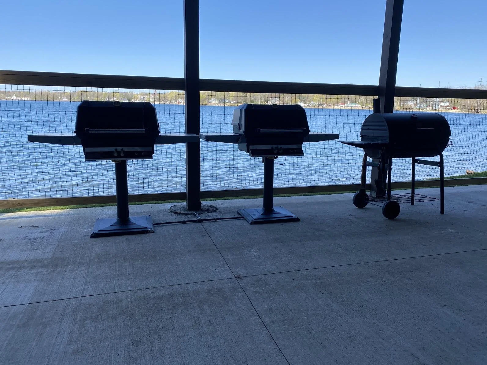 Patio has 2 natural gas grills + 1 charcoal grill. Wrap-around fence keeps little ones away from the lake...peace of mind for parents.