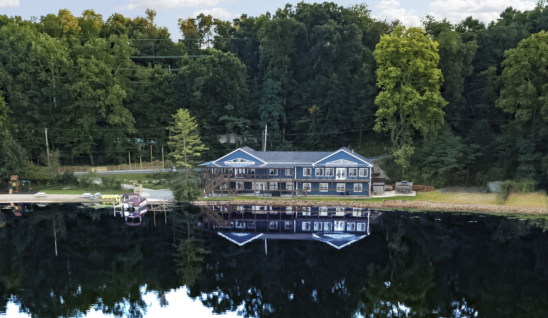 The house sits on 340 ft of lake frontage w/ 101ft deck and 80ft private beach. 2 grassy, level play areas.