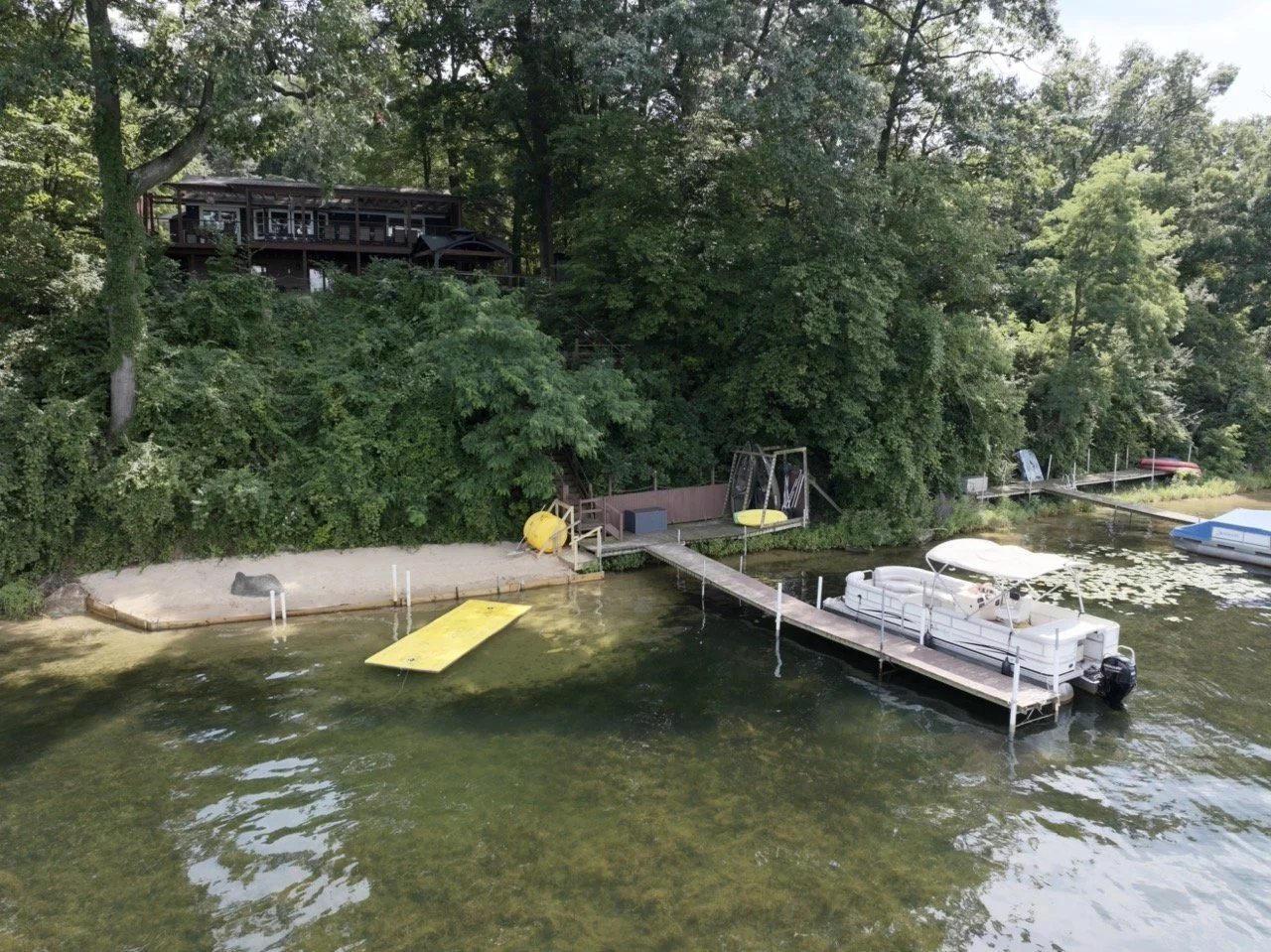Private sandy beach has very gentle slope into the water.