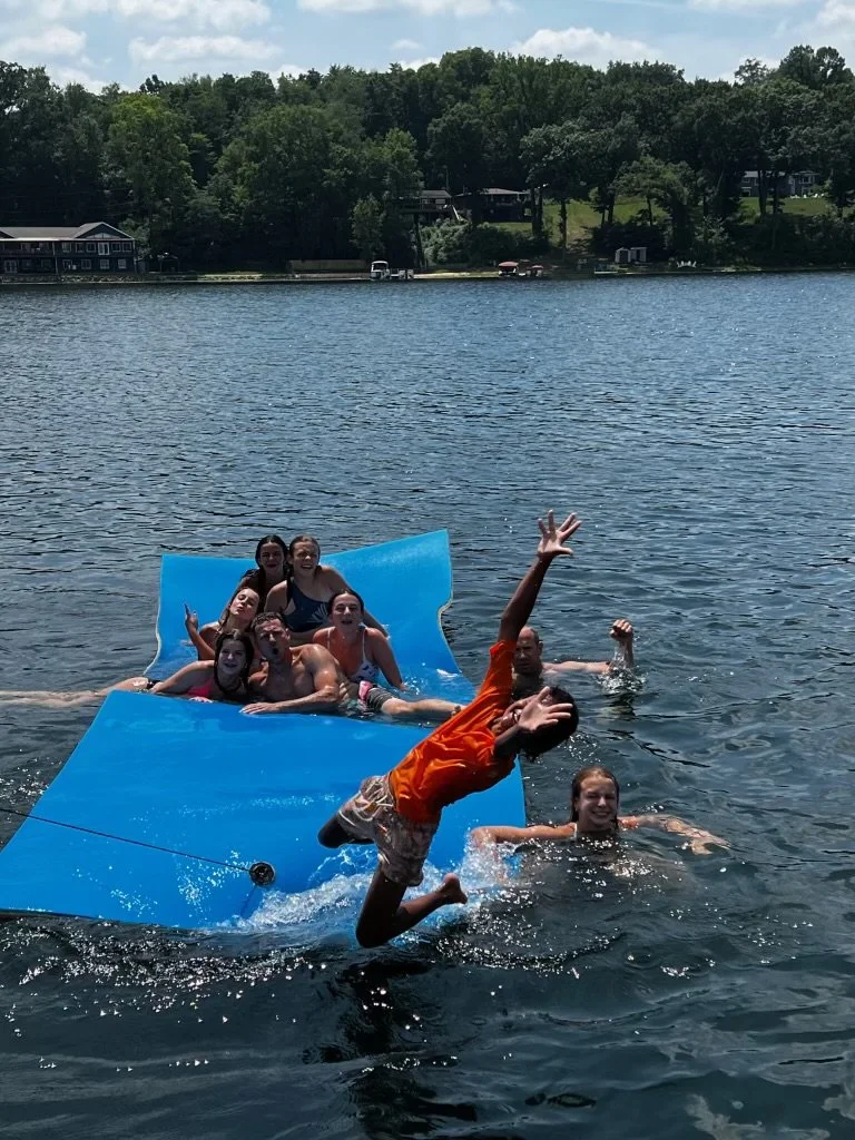 Guests having a blast on Stone Lake on one of the lily pads (included with Pontoon Boating Pkg).