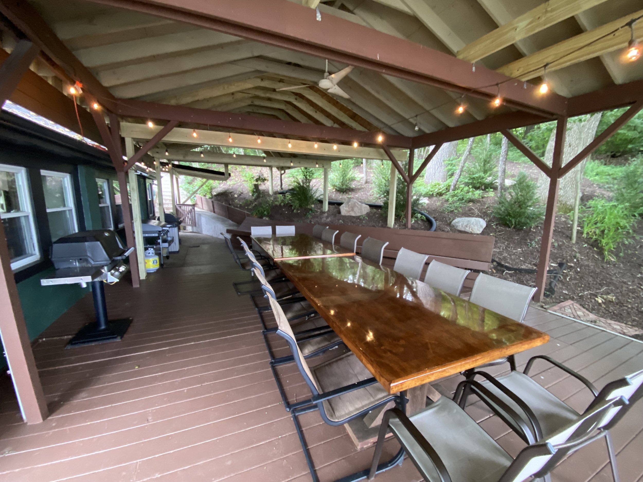  The secluded large rear covered deck features ample seating, gas and charcoal BBQ grills, plus 36in Blackstone Griddle 