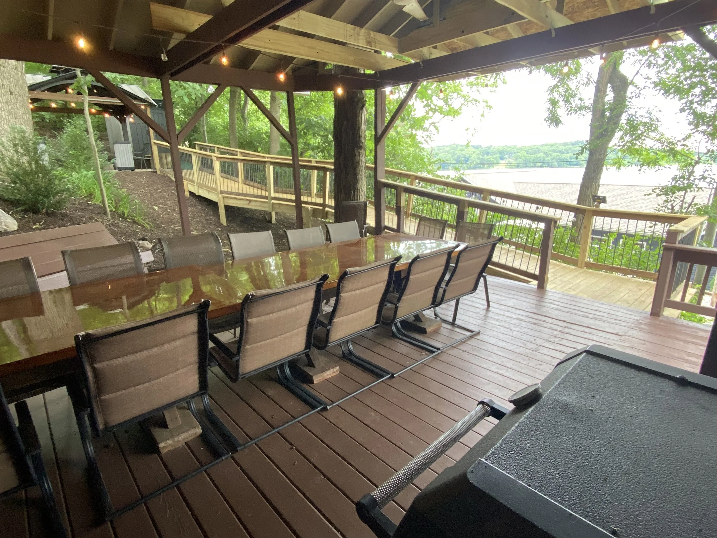  A wheelchair-friendly ramp connects the rear covered deck with the firepit gazebo &amp; adjacent firewood shed. 
