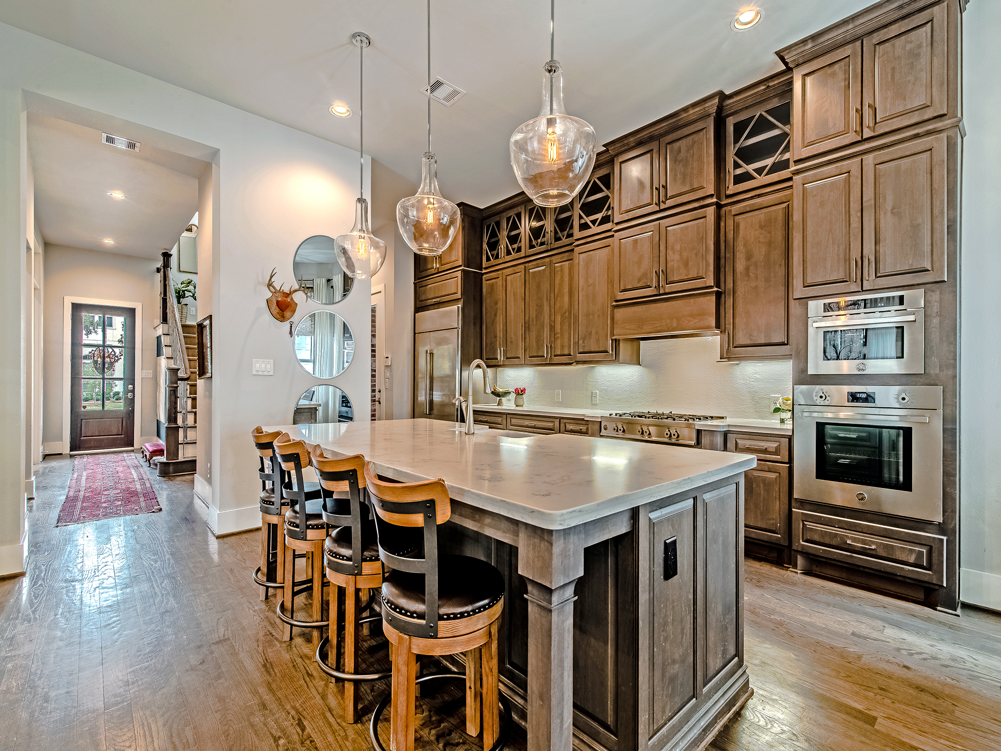 Kitchen features custom, ceiling height cabinetry and Bertazzoni appliance package.