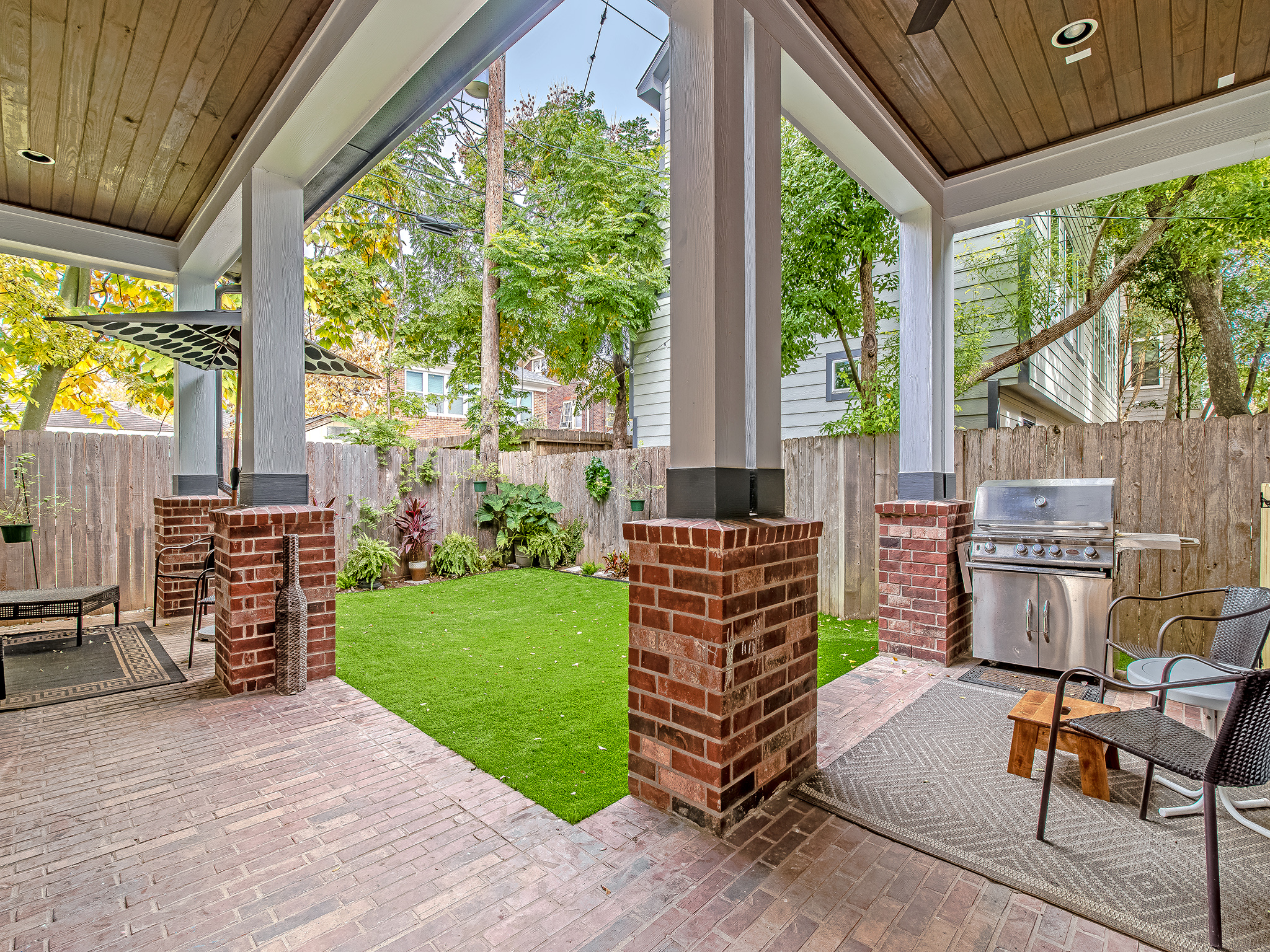 Gorgeous backyard features ample patio space, turfed play space and flower beds.